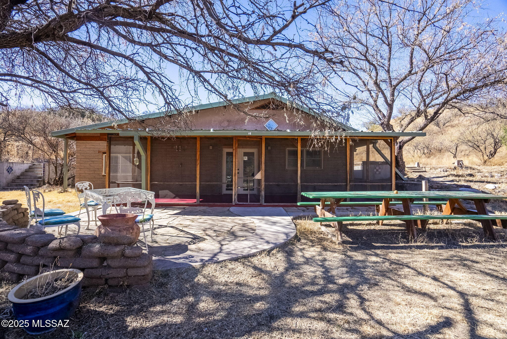 Charming split level adobe house nestled in the outskirts of Patagonia with views of Red Mtn and bordered by the Nature Conservancy.  It is within walking distance of the Audobon's Paton Center for Hummingbirds and the Sonoita Creek Preserve and downtown Patagonia.  The upper level of the house has a large vaulted great room , master bedroom & bath.  The lower level has a spacious open concept kitchen, dining area, bedroom, office or 3rd bedroom and pantry/laundry room.  Other features include spacious yard, large screened in porch and wonderful guest casita with kitchen, bath and loft bedroom.  Tucked away in the mesquites this is a must see.