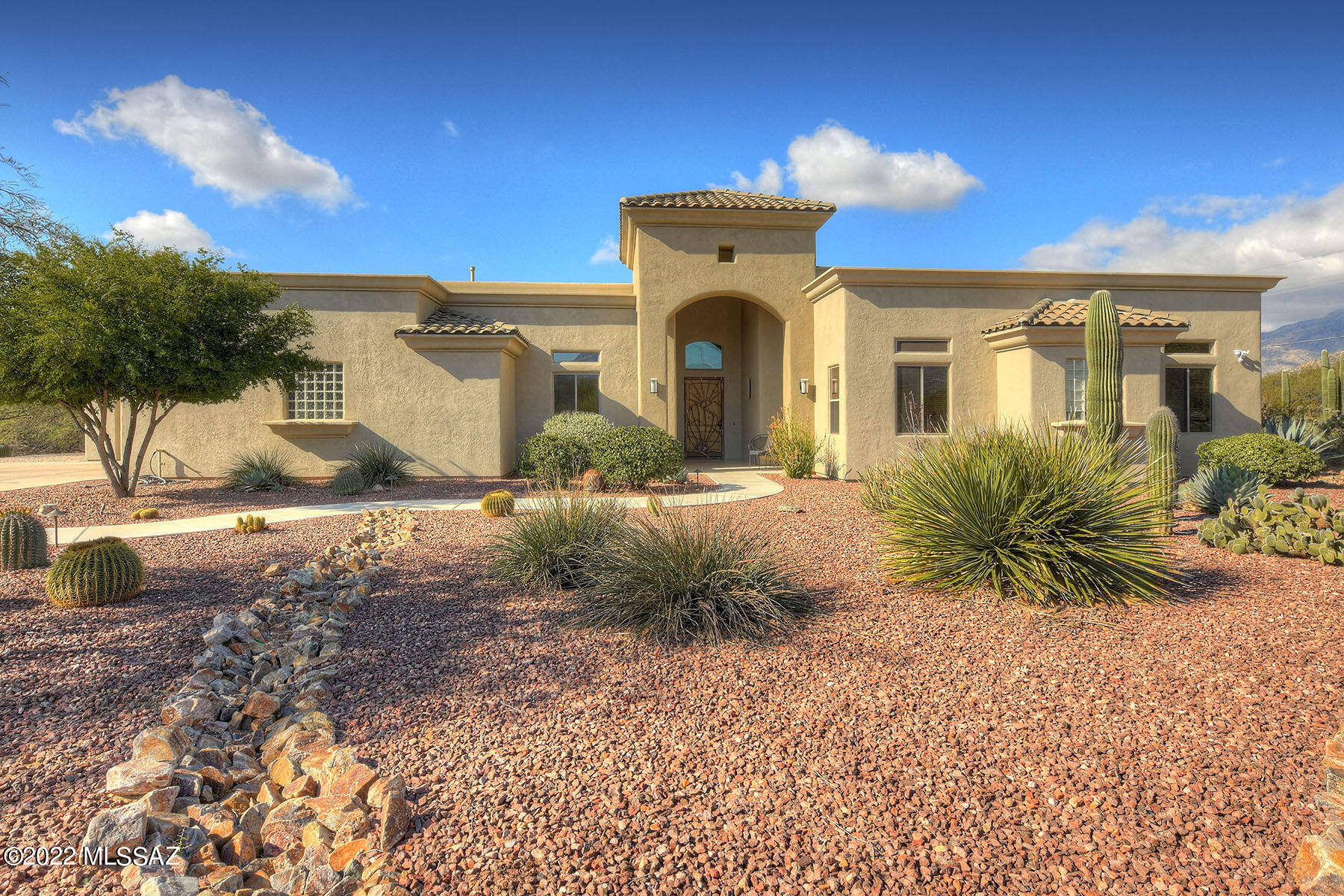 Stunning custom home built on 1.2 acres w/spectacular Mountain Views. Fabulous kitchen offers cherry cabinets, granite countertop & island, 6 burner gas cooktop perfect for those who enjoy cooking! Great room off Kitchen features a see thru fireplace & striking mountain views. A separate dining room for dining or another living space. Luxurious Primary Suite features, beautiful bath, walk-in shower, two separate vanities, extra-large walk-in closet & access to the backyard. Den w/built in cherry cabinets & bookshelves, 2 additional guest rooms w/Jack & Jill bath & separate powder room round out the living space.  Mega RV garage & workshop area w/additional 2 car garage. Resort like backyard with pool/spa, outdoor fireplace w/bancos & views galore. Owned Solar. A very special home!
