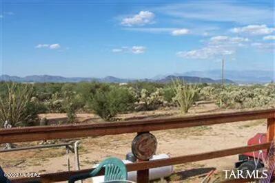 BEAUTIFUL PROPERTY PEACEFULLY SITUATED IN SAHUARITA. 3 Bedroom and 2 Bathroom home on 7 Acres. Isolated and  Amazing View of Tucson and Catalina Mountain Range from Back Porch. Barns located on property with the ability to stall 5 horses. Perfect for families and pets looking for peace of mind. Quick access to the town of Sahuarita and Tucson. Second Property Adjacent is also for sale. New Flooring and Stove within the home. Home is being sold as is.
