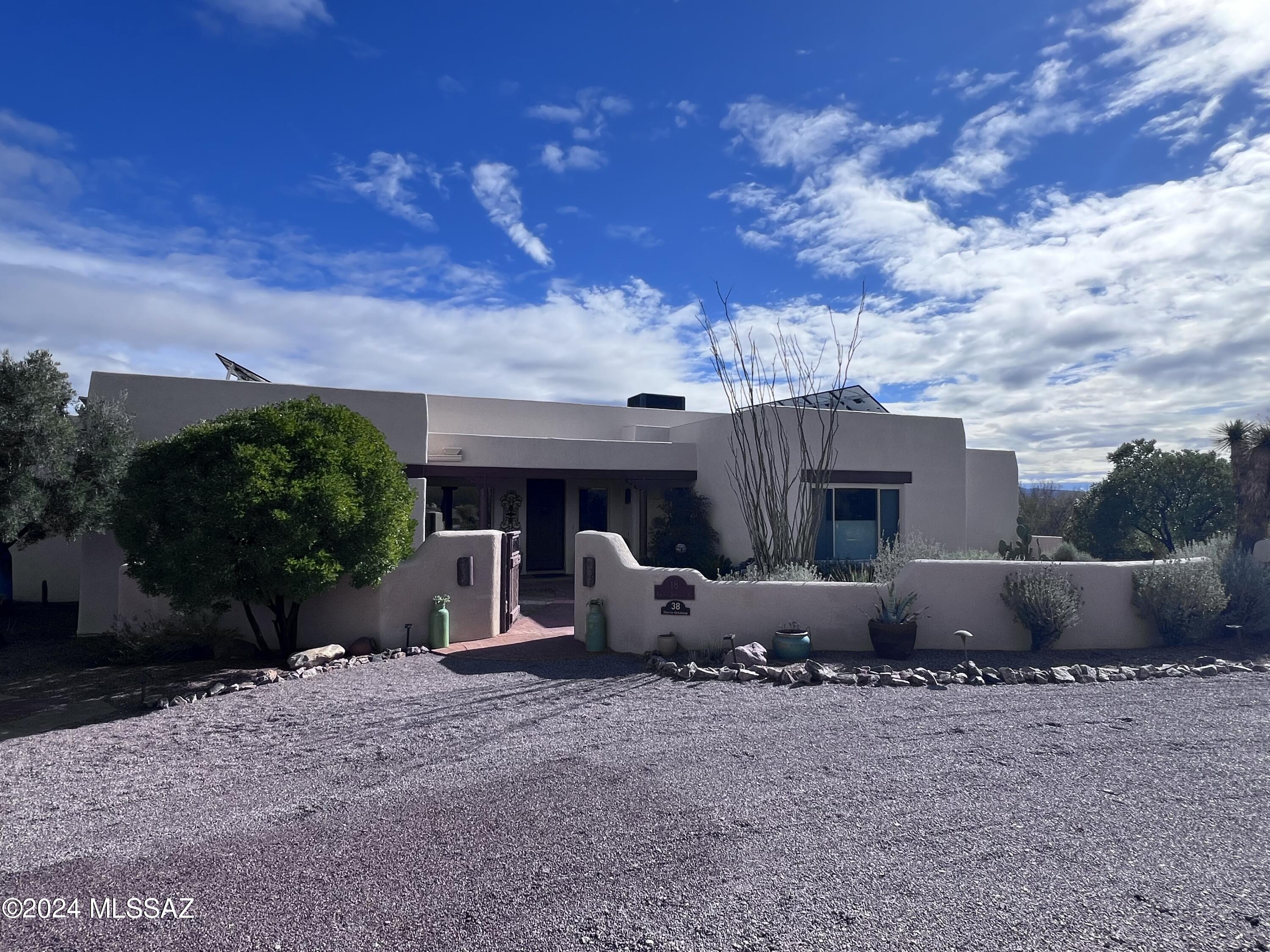 Ever changing blue skies call you to the windows of this beautifully maintained, comfortable, quiet home.  It has been built with energy efficient insulated concrete foam block and it also has solar installed.  Enjoy both sunrise and sunset expansive mountain vistas from this 2905sf split bedroom home that is situated on four acres, just two miles from the historic village of Tubac.  This home includes an attached spacious 3 car garage with epoxy coated floor and a mini-split.  No HOA or deed restrictions.  RV parking adjacent to the garage with 50 amp service and water.  Enjoy Southwest living at its finest.