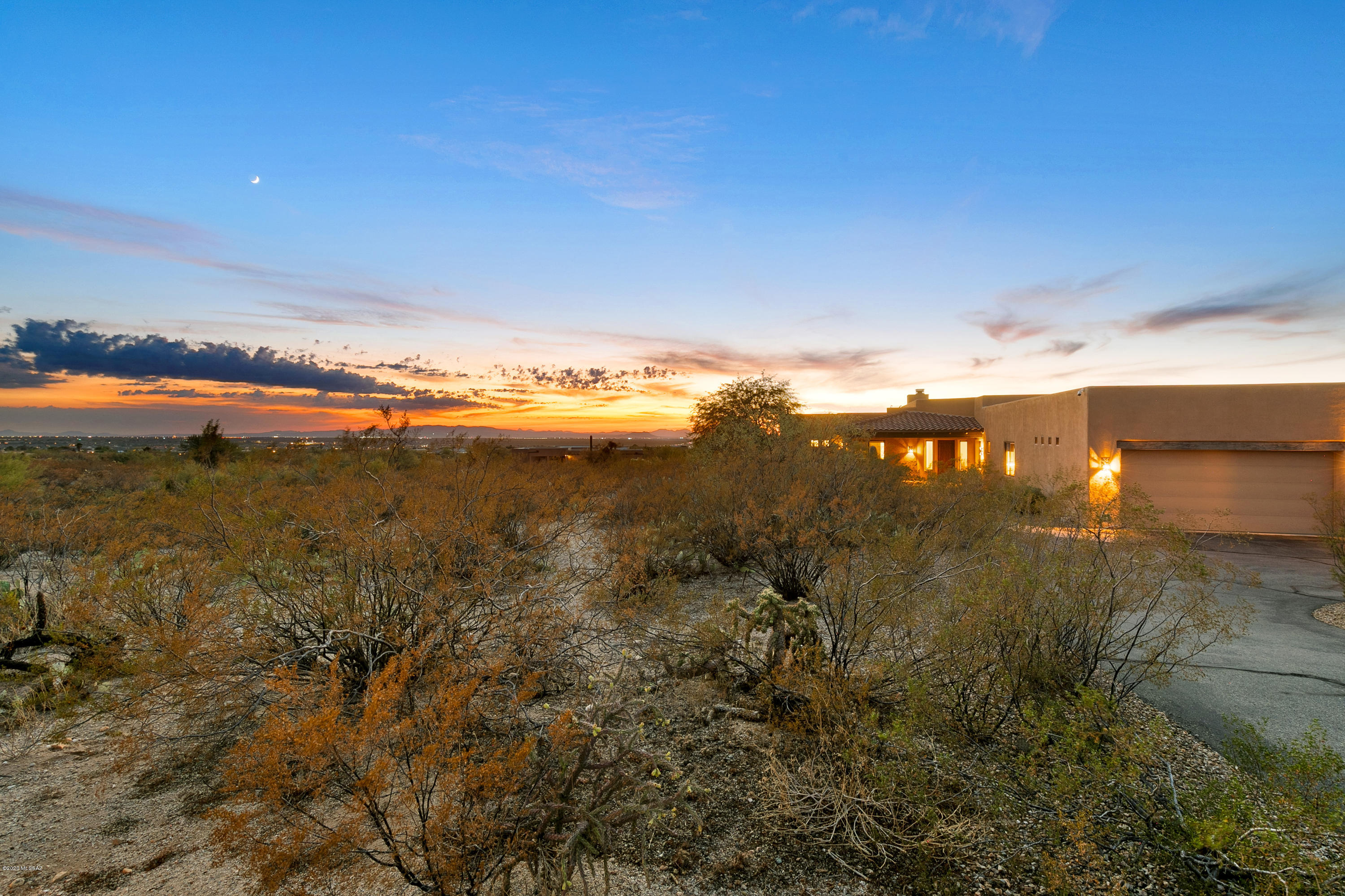 SPECTACULAR 4 bed/4 bath custom home built in 2007 on a 3.3 ACRE ELEVATED LOT with 360-degree views! Enjoy sunset, city, and mountain views and even better: NO HOA! Minutes from Saguaro National Park with 2 covered patios and covered front porch. 3-car garage, spacious laundry room, and pantry provide plenty of storage. Private lot and private road with extra bonus of community feel! Fantastic floor plan with great room, and adjacent area in master bedroom for office, nursery, exercise, or sitting room. Natural light and skylights throughout home, high end finishes, including natural stone, granite, cherry wood, and custom interior doors. Don't miss this beautiful home in a serene setting. This is true southwest living at its finest! See photo captions for more details.