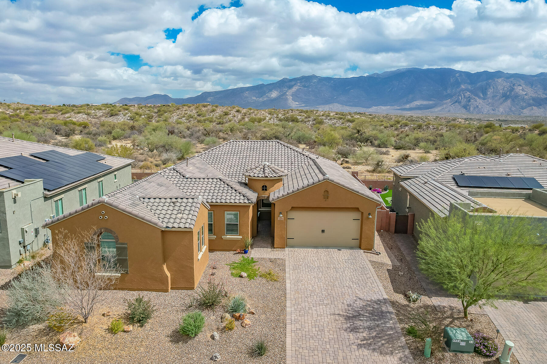 Exquisite, newer 4BD/3.5BA + Den (3,194 sq ft) home in gated Alterra at Vistoso Trails boasts spectacular Catalina mountain views from rear yard bordering the Hohokam Nature Preserve. You'll be greeted by a charming cobblestone drive, walkway and courtyard. This home also features a 3-car tandem garage. Enter to find luxurious details throughout, high & recessed ceilings, wood shutters & blinds, porcelain plank tile with carpeted bedrooms, plus a Family room in guest wing. Great room plan showcases walls of windows accentuating the views plus living area with chandelier and dining area off kitchen. Gourmet kitchen hosts large center island, quartz countertops, stainless appliances including in-wall ovens & electric cooktop, butler's pantry with wet bar/wine cooler and large walk-in pantry. Formal dining room can be accessed from foyer and kitchen. Lovely Owner's suite hosts a granite-top dual sink vanity, extended walk-in rainhead shower plus elongated, custom walk-in closet. Guest suite lies off Family room and hosts ensuite bath with tiled shower. Two additional bedrooms, hall bath, laundry room with sink plus powder room. Retreat to a spectacular, easy care yard with extended cobblestone pavers, decorative turf areas, covered patio with rolling sunshade, block/view fence and no one behind. A perfect desert retreat for the most discerning buyer!
