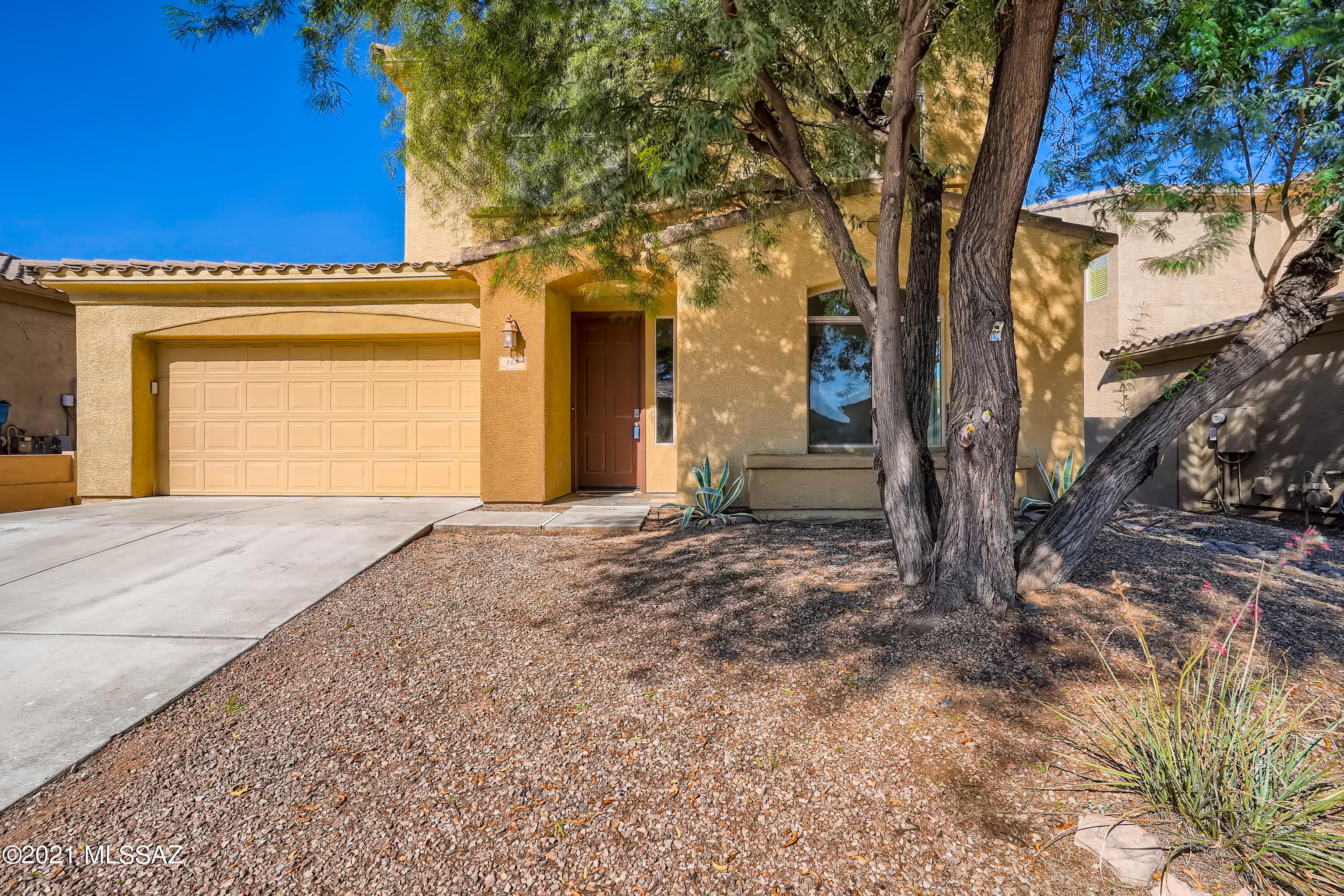 Location, location, location! Get ready to enjoy this 3 bedroom, 2.5 bathroom home in the esteemed Encanto Del Lago, a gated community in Rancho Sahuarita. Inside, you will find a spacious formal living room, a family room that adjoins the eat-in kitchen, complemented by natural light and stylish interiors, flowing together in a user-friendly open floor plan concept. The kitchen offers ample cabinet space, a center island with breakfast bar seating, and built-in sleek appliances. The light-filled primary bedroom boasts a huge walking closet, an en suite bathroom with dual vanities, and a separate soaking tub. Step outside into the expansive low-maintenance backyard with a covered patio to unwind after a long day of work. Located close to Club Rancho Sahuarita, shopping, dining, and more!