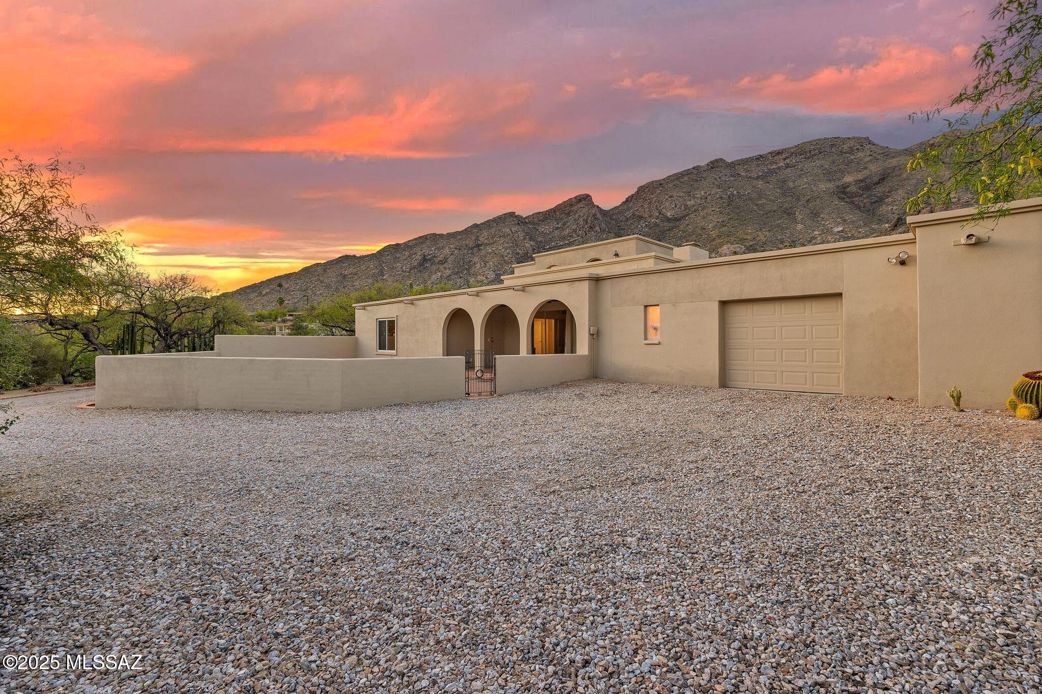 Nestled at the base of the Catalina Mountains, this stunning home is located within the prestigious gated community of Skyline Country Club Estates. Thoughtfully updated with fresh paint and a new roof, the home exudes timeless elegance featuring warm wood flooring, marble accents, a striking stone fireplace, and sleek stainless steel appliances.

With 4 spacious bedrooms and 4 bathrooms—including a private guest studio with its own entrance—this home is ideal for hosting out-of-town visitors. A large workshop/garage with an adjacent bathroom offers the perfect space for hobbyists or extra storage. Residents of Skyline Country Club enjoy exclusive HOA benefits, such as complimentary access to a state-of-the-art fitness center, a monthly golf and tennis pass, and a vibrant calendar of special club events throughout the year.

This is Tucson luxury living at its finestdon't miss the opportunity to make it yours.