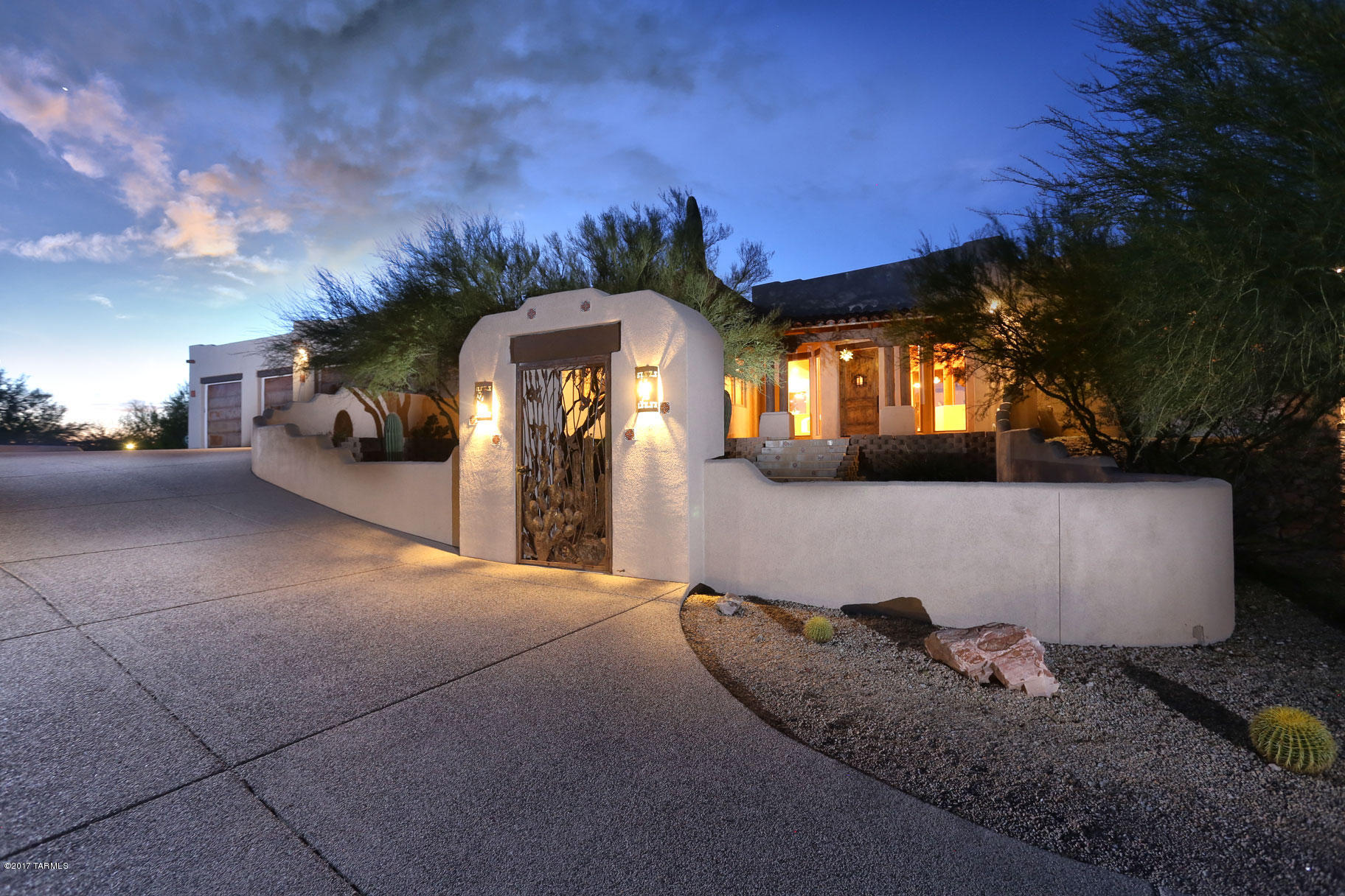Meticulously maintained custom built home within small, gated enclave. Situated on 3.5 + acres of total privacy & open sky. Thoughtfully built & designed, unobstructed views upon entering the home through an inviting courtyard. Open, spacious, greatroom floorplan perfect for entertaining. High tongue & groove & beamed ceilings, walls of windows & lots of natural light. Open kitchen overlooks backyard & pool, has hand crafted cabinetry, expansive granite counters include island & bar seating. Luxurious main master suite (there are 2) with patio access. Stunning resort style pool with swim up bar, ramada & kitchen! Enjoy easy access to miles of trails for riding & hiking  Saguaro National Park. Impeccable, oversized garage with workshop & storage rm. 3 stall horse facilities, lights & wat