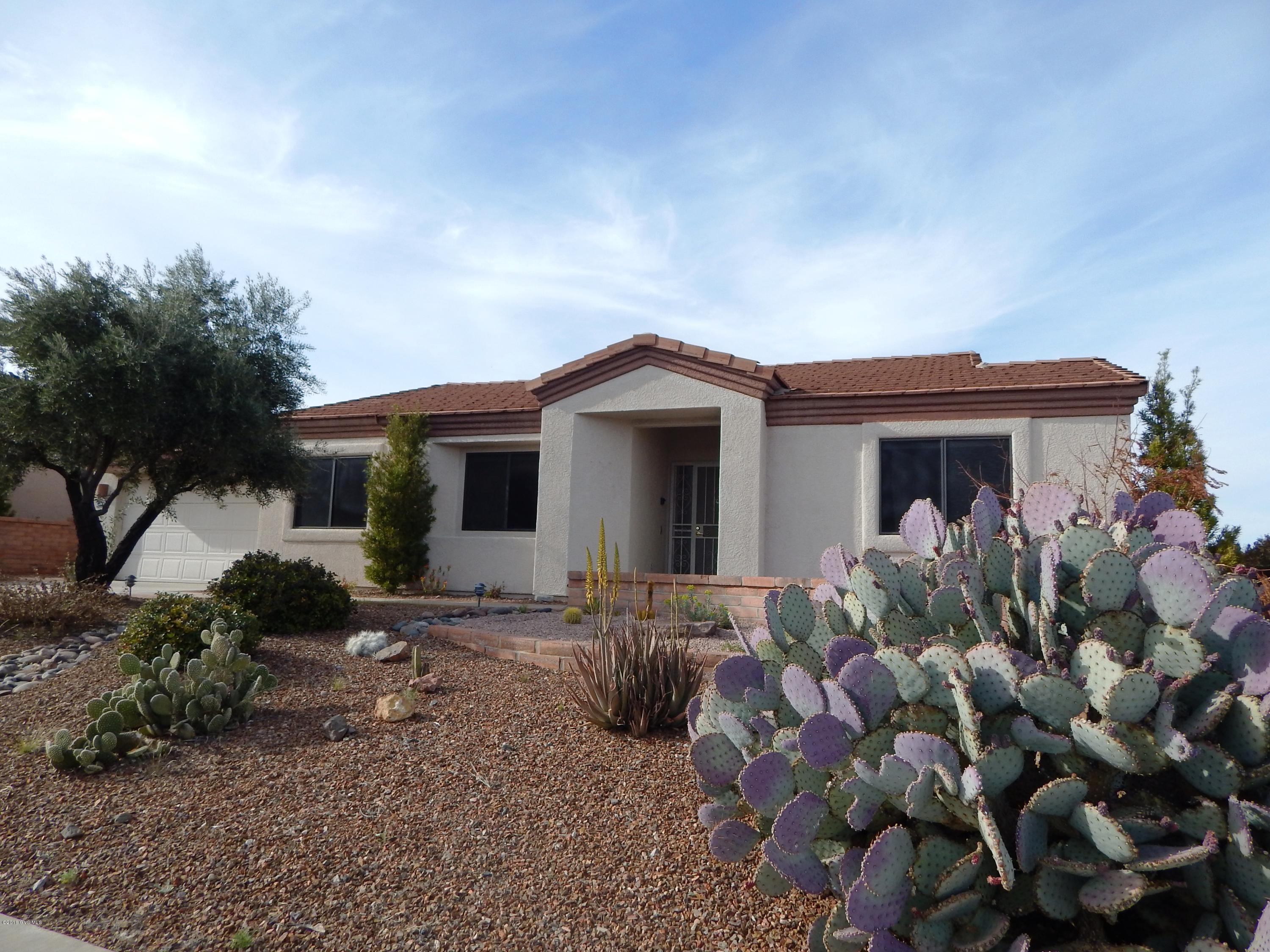 This beautiful San Ignacio Vistas home has stunning views out virtually every window! The home is perched high on a ridge above the San Ignacio golf course with panoramic views of the mountain ranges to the north and west. From the front patio, the living room and guest room you have excellent views of the Santa Rita Mountains. You will love the versatile floor plan with formal living and dining area and extended family room with neutral tile in all the right places. The exposed beam and built-ins give the family room a touch of character. The kitchen is open to the family room and has attractive stainless steel appliances. The laundry room is large with space for a desk, hobby area or storage. The master bedroom has a slider offering access to the patio and over sized backyard.