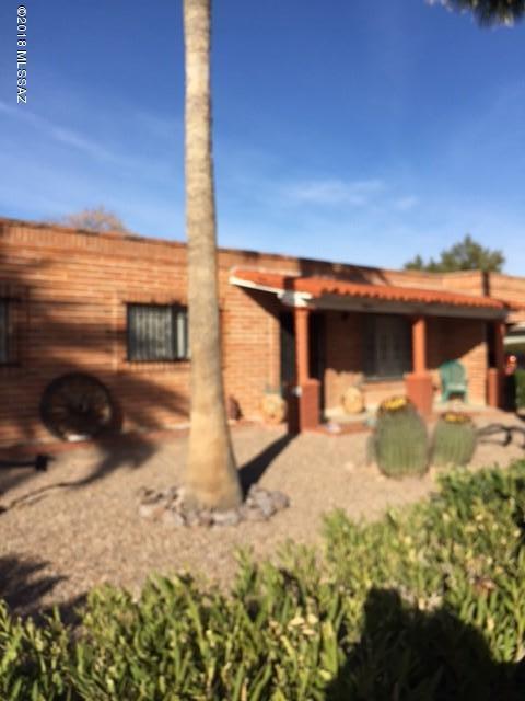 Solid Burnt Adobe Territorial, Many Updates, Gas FP in Family Room, Separate Workshop, Private Lot with 6' Block Wall. Intercom, Ceiling Fans, Security Bars, Large Covered Patio, Dog Run Area. Close to Tucson Medical Center. Hot Water Heater 4 years old, Furnace and A/C 2.5 years old, A/C is a 16 Seer. Owner holds an Arizona Real Estate License.