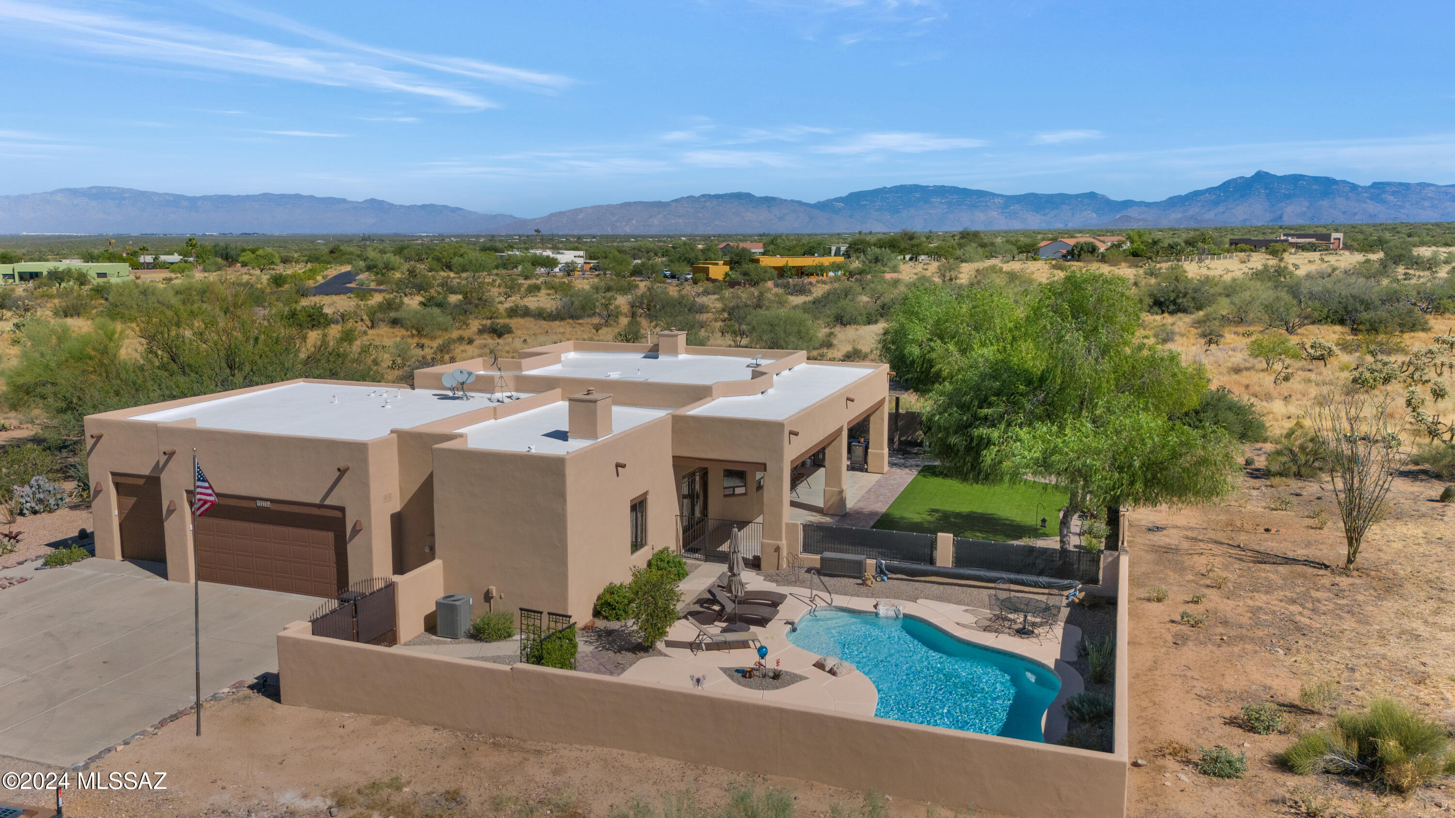 An oasis in the Sonoran Desert! Experience breathtaking views from every room in this spacious 3bd+den/2.5ba home situated on over 4 acres in gated Sycamore Springs in Vail. Owners poured nearly $200k updating this home over the last two years, intending to make it their forever dream home - and now you get to benefit. Energy efficient ICF construction = super low utility costs. Chef's kitchen with new appliances features knotty cherry cabinets, an island, pantry and plenty of storage overlooking backyard and great room with captivating Santa Rita mountain views beyond. Backyard wall has been transformed into a view fence that brings the surrounding desert and mountains closer. Wonderful for watching the native wildlife as you gaze across the new turf, shaded trees and easy-care landscape from your position on the full-length shaded patio. A sparkling pool is separately fenced with soothing waterfall feature.
Owner's suite has private backyard access, a dual-sided fireplace (bedroom & bath), and a sumptuously remodeled bath with spa shower, soaking tub all displaying custom marble and quartz, and a large closet. Nearby is a powder room, laundry room and oversized 3-car garage. On the other side of the home, you'll find 2 bedrooms, another updated bath and a convenient den/office. The great room has soaring ceilings, a beautiful beehive fireplace, and slider to the yard. 2 new 16 SEER HVACs in 2023, 2 water heaters in 2021, recoated roof in 2022.
Situated in award-winning Vail School District, a quick trip to the Pima County Fairgrounds, and a 30-minute drive to Colossal Cave and the rich wine culture, scenic hiking trails, and historic attractions at Sonoita-Elgin, AZ, this home has it all. Move in and start living larger - there's nothing to do but enjoy.