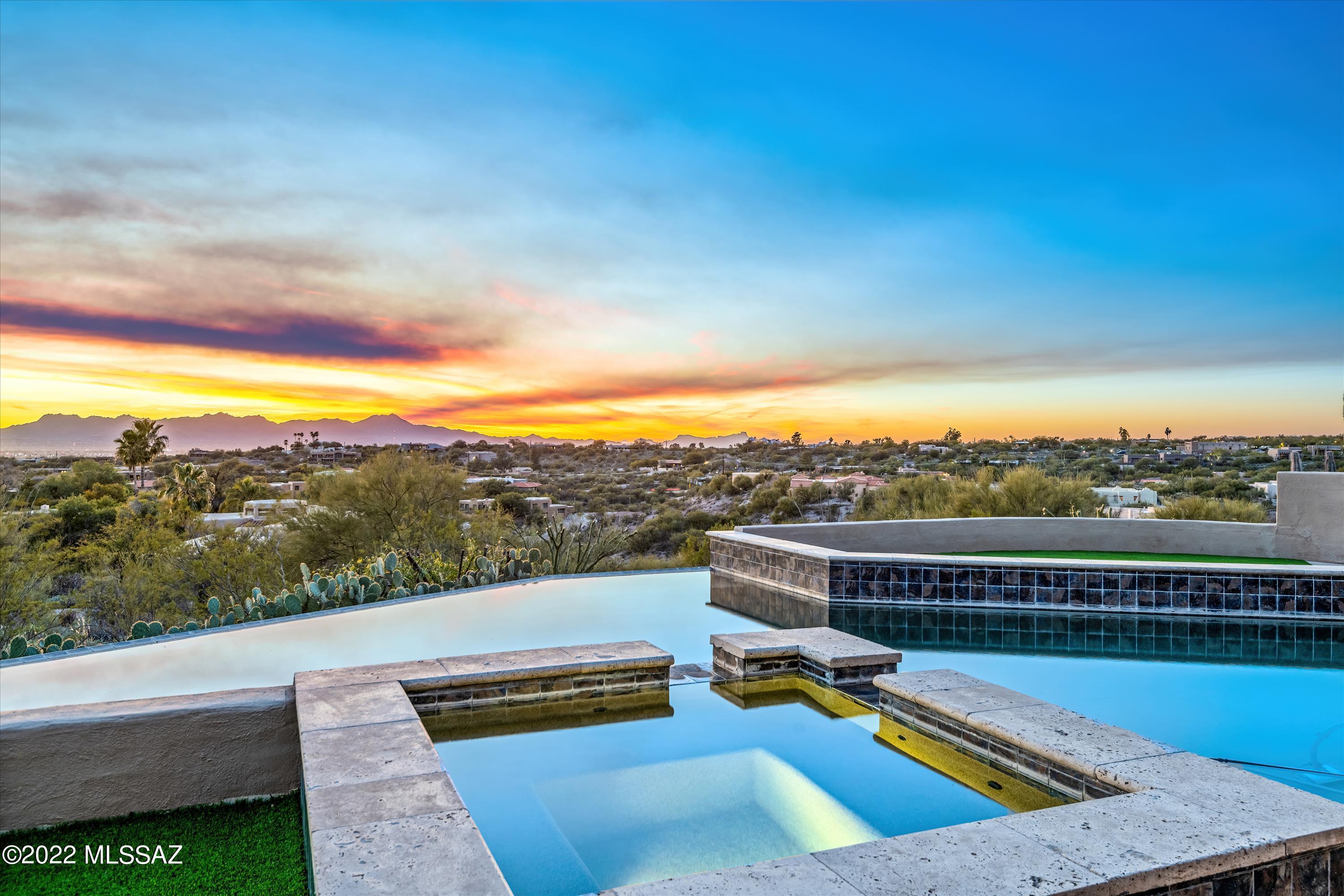 Views on Views!!!

This spectacular contemporary will take your breath away.  Guard gated in one of Tucson's finest communities. We present this completely renovated modern masterpiece where tranquility meets luxury.  Beautiful porcelain flooring throughout, Thermador gourmet kitchen with custom contemporary cabinetry. Walls of cabinets in the grand butler's pantry, and soaring ceilings throughout the home.  This property features modern top of the line finishes everywhere you turn. 4bd/3 1/2 ba masonry stucco construction, paver circular driveway with additional lower parking area.  Walls of windows capture 360 degree beauty of our sonoran desert and twinkling city lights. Brand new roof and hvac's This home is situated on 1.83 acres of private living space.