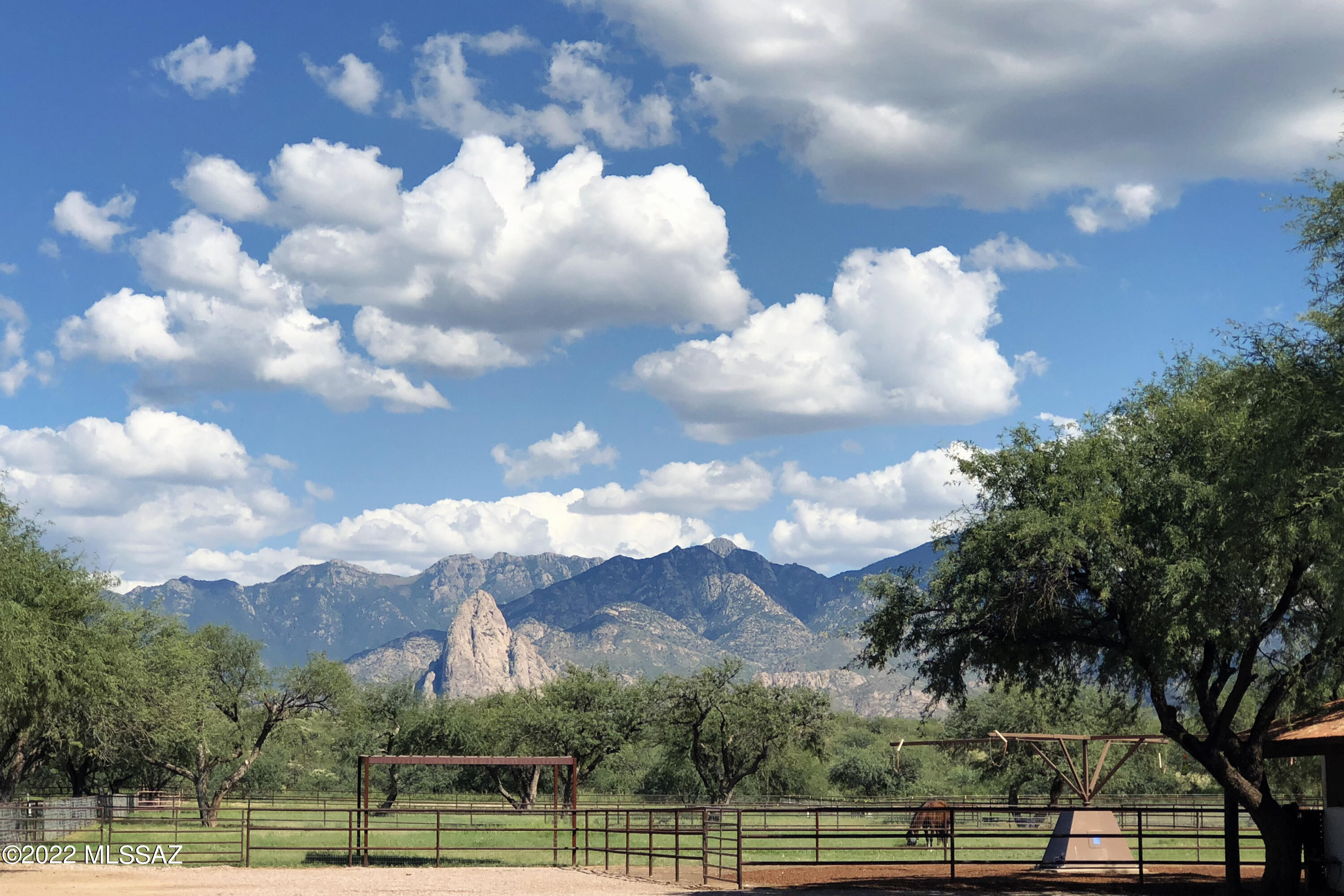 Nestled at the base of the Santa Rita Mountains and conveniently located near Tucson, Green Valley, and Tubac, this remarkable 160-acre horse and cattle ranch offers a rare blend of historic charm, natural beauty, and modern amenities. Adjacent to the property is a 6,000-acre Arizona state grazing lease, ideal for horseback riding, hiking, nature watching, and hunting. The ranch has deep roots in the region's history, once part of the Canoa Land Grant and later owned by the Amado family, after whom the nearby town is named.

SEE MORE... The ranch features two attractive residences at its headquarters, perfect for owners or extended family, along with four additional homes for guests or staff. Designed in a harmonious Colonial Spanish style, the buildings blend seamlessly with the landscape. The main house, custom-built manufactured home by the current owners, includes north and south porches, paved patios, a fountain, and native gardens designed to attract birds and butterflies. Inside, the home boasts high ceilings, quality wood laminate floors, stainless-steel appliances, barnwood-style cabinetry, a farm sink, and an open living-dining area with a wood-burning stacked stone fireplace. Sliding glass doors lead to a covered terrace with panoramic views of irrigated pastures and distant mountains. A spacious carport and a large, barn-style garage with insulation and climate control sit nearby, offering ample room for vehicles and storage.

The second residence, known as "The Casita," includes three bedrooms, two and a half baths, an office, and a laundry room. Set in a fully fenced yard with a front porch, garden, rose beds, and a large fountain, this home has also been thoughtfully upgraded. The master suite includes a renovated bath with a soaking tub and walk-in closet, while the living room features a charming custom-tiled fireplace. The durable metal roof and shaded backyard enhance both comfort and practicality.

Designed for serious equestrians and ranchers, the property includes 80 acres of irrigated pastures divided by solar electric fencing, stallion corrals, dry lots, and several working arenas. A roping arena with alley, squeeze chute, and breakaway setup complements additional facilities including a dressage court, three round pens, a hot walker, and covered vet stocks. Historic retorque corrals, now rare in the region, still remain. The original adobe barn, featured in John Wayne westerns, adds to the ranch's rich legacy. All stalls are oversized, with most measuring 12 by 24 feet, while the Show Barn offers 12 by 16 stalls with turnouts. This barn also includes an air-conditioned tack room, ADA-compliant bathroom, kitchen, laundry, and a wide paved aisle ideal for events. Outdoor spaces accommodate tents for gatherings, weddings, or ranch events.

In addition to the extensive equestrian facilities, the ranch includes pastures, tanks, working pens, troughs, and ample water from multiple wells on both the deeded land and the state lease. A large machine shop, hay barn, and secure storeroom with roll-up doors complete the infrastructure.

Located just ten minutes from the artistic and historic town of Tubac and thirty minutes from Tucson, with its major university and international airport, the ranch is both secluded and accessible. It is directly across from the 4,000-acre Historic Canoa Ranch, owned by Pima County and restored as a living history site offering cultural and educational events. A recently upgraded county-maintained bridge (suitable for hay trucks, horse trailers and heavy equipment) over the Santa Cruz River provides reliable year-round accesscritical in a region where some river crossings are seasonal.

This ranch offers endless possibilities. It could serve as a private family compound, a working horse and cattle operation, a corporate or wellness retreat, a guest ranch or equestrian resort, or even a luxury equestrian community. With a shallow water table, abundant water, exceptional facilities, and unmatched location, there is truly nothing like this property in Southern Arizona.