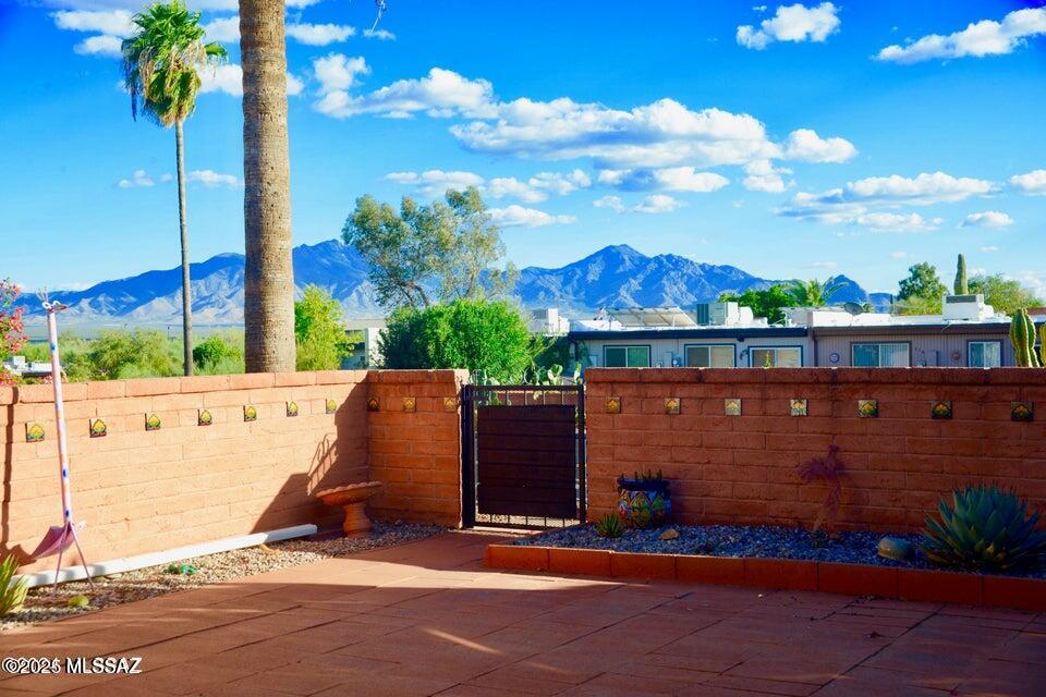 Lovely 2-bed 2-bath townhome boasts breathtaking Santa Rita Mountain views, delivering the serene backdrop you are looking for! Light & bright, the home features modern updates throughout, including all-tile flooring & no popcorn ceilings. The well-designed layout offers 2 spacious living rooms, providing ample space for entertaining and hobbies. The 2022 kitchen is a chef's delight, equipped w/ stainless steel appliances, elegant quartz countertops, gorgeous backspalsh, soft-close cabinets, & double-layer drawers for optimal storage. Enjoy peace of mind with new HVAC (2022), updated windows & treatments, & contemporary lighting(2022). Step outside to a low-maintenance paver patio with multiple seating areas, perfect for soaking up the mountain view.