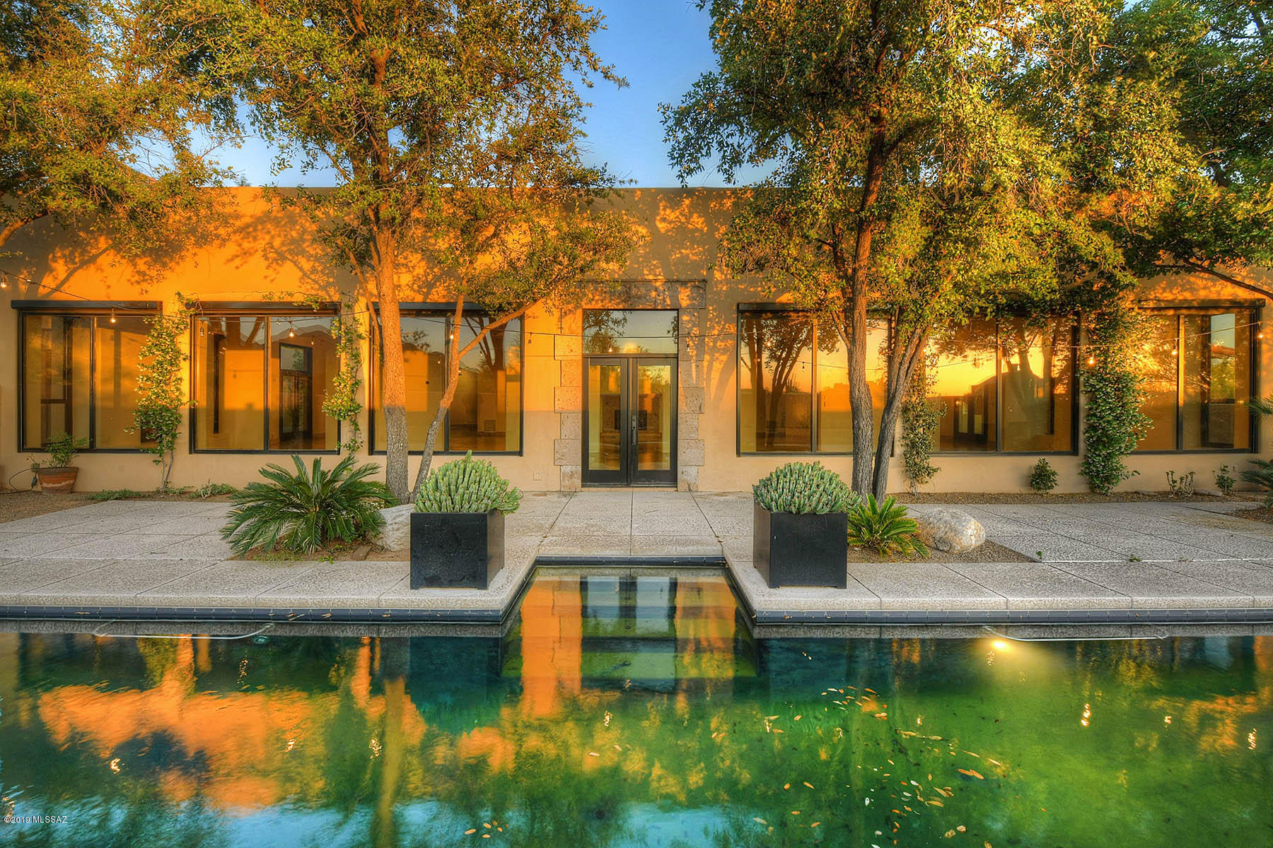 Santa Barbara & Contemporary Elegance blend inside a private, gated brick-paver courtyard, enter main house through a stunning custom contemporary steel & glass swing door, all new gleaming concrete flooring, gracious open floor plan featuring lofted ceilings, dramatic gallery living & family rooms, wall of windows, 3 fireplaces, entertainers eat-in kitchen,  master suite incl completely new master bath w/ slate shower wall & luxe fixtures, soaking tub, new (huge) master closet w/built-in laundry, split bedroom plan, home office/den, formal & informal dining space, fabulous expanded yard w/ new hardscape & wall enclosures, built in BBQ, gorgeous pool, spiral staircase to roof, full separate guest house w/living room, kitchen & bedroom, 3 car garage, patios galore, mountain & sunset views!