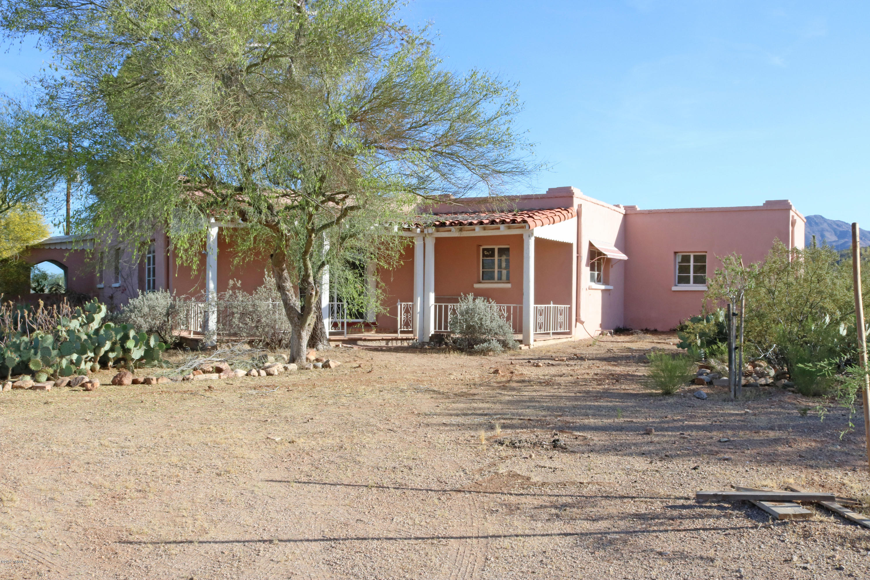 Price Reduced! Don't miss this Rare opportunity! Cherish panoramic views of the mountains (Sombrero Peak), Catalina mountains, City lights, and breathtaking sunsets. This classic adobe house is a fix up just waiting for your additions and upgrades to create the home of your dreams. Located minutes from I-10 and Saguaro National Park West, shopping, schools, parks, library & fine restaurants. Private Gated location. Horses allowed.