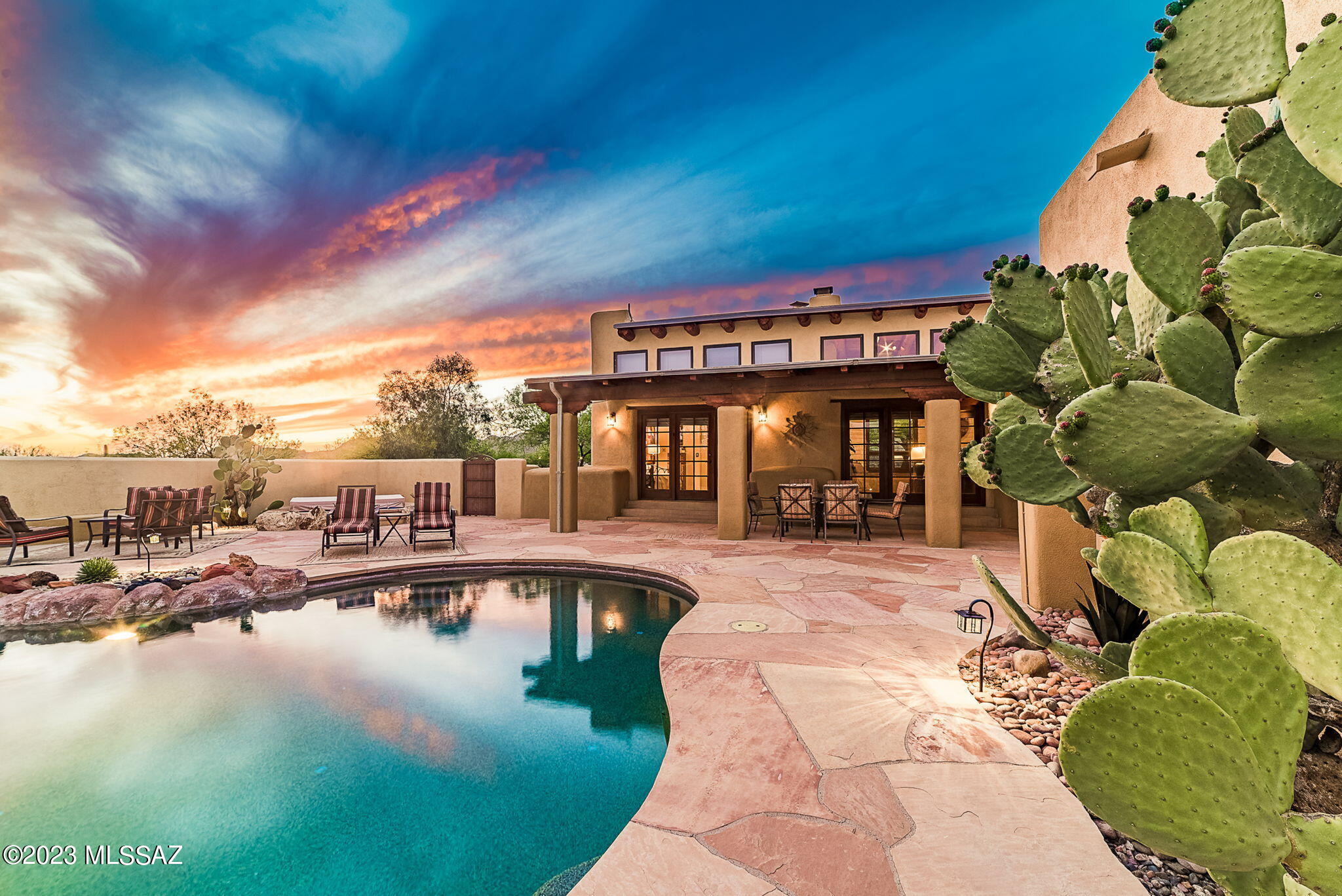 Solid mud adobe constructed Santa Fe home tucked away on just under 3 private acres at the base of the Tortolita Mountains. NO HOA Upon entry, you are greeted with 14' wood-beamed ceilings in the main living area, large windows looking out to the front courtyard and a massive fireplace lending warmth. A wall of French doors looks out to the expansive flagstone patio and heated Pebbletec pool. Step down into the large kitchen featuring a kiva fireplace tucked in the corner, wet bar and access to the patio/pool area. Beautiful scored and stained concrete floors throughout. Radiant flooring in half the home. Enjoy morning coffee poolside with sunrises over the Catalina Mountains and sunsets over the Tortolita Mountains next to the outdoor kiva fireplace. Featuring 4 bedrooms in the main hous Featuring 4 bedrooms in the main house (2 of those featuring private patios and the master suite having a walk-out onto the pool area in addition to a kiva fireplace). Traditional mud adobe home offers unparalleled energy efficiency thanks to it's thermal mass. Read more about this unique but very traditional construction in the article under the documents tab. 

Guest house has ample space and storage. Ideal for guests, or a vacation rental/bed and breakfast as an income property. Excellent location 10 minutes from the freeway, 25 minutes to the University of Arizona. Large fenced yard could be a garden or dog run. 2.98 usable acres with plenty of room for horses. 4 car tandem garage to house the cars/toys and a separate covered RV port. Monsoon waterfalls just a short hike away and miles upon miles of hike/bike/horse trails to explore. New private well drilled 2020. Fresh exterior paint April 2023. Read more about all the features of this wonderful property under the documents tab. Too many to mention here!

Wonderful investment opportunity as there are 3 spaces that could be rented. Full shaded RV hookup with power, water and septic access. True turnkey opportunity as everything conveys with the home. Close escrow and start earning!
