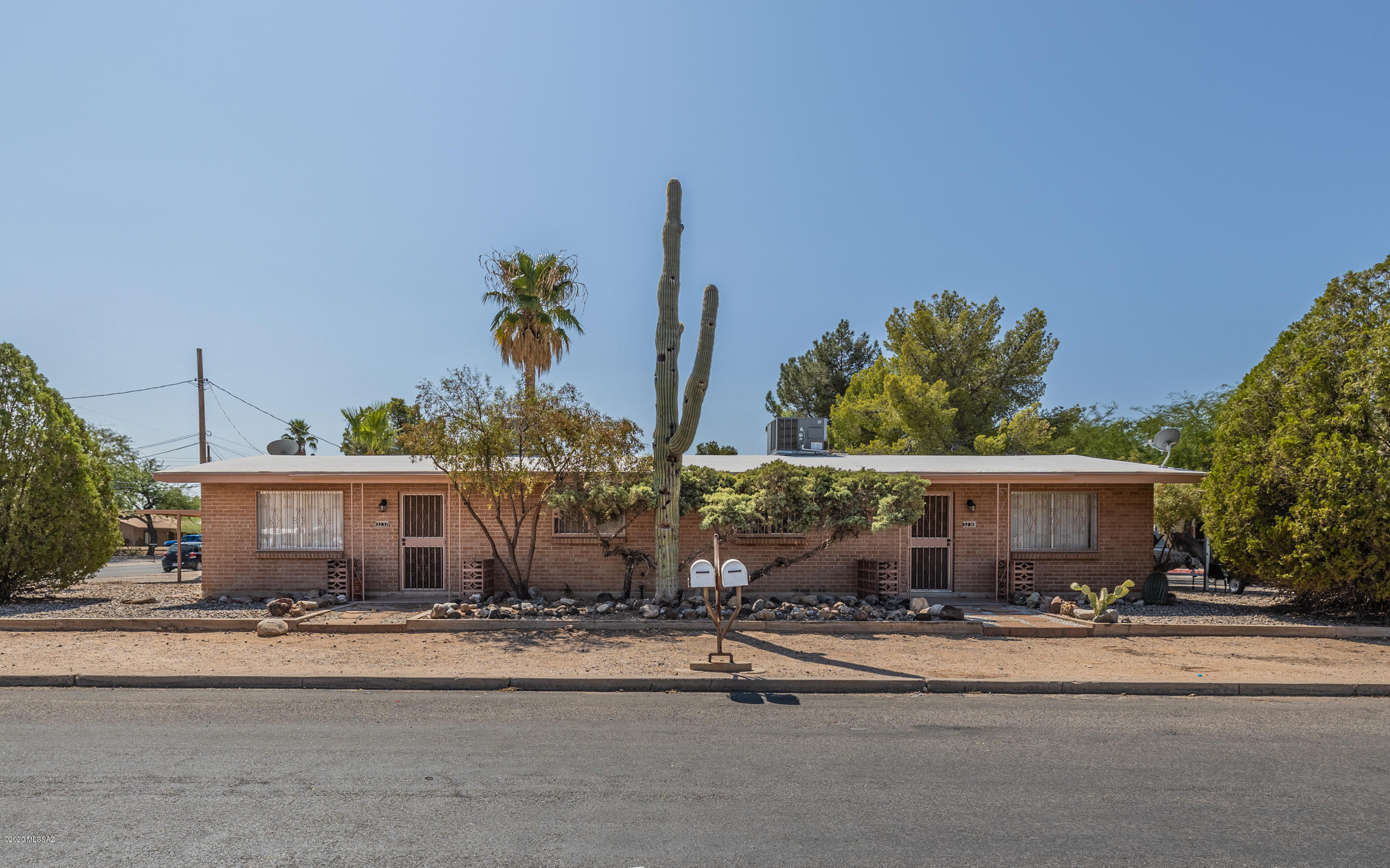 Brick duplex conveniently located in Central Tucson with Mountain Views. Each unit has 2br, 1ba, fenced yards with patios.  2 car  & 3 car carports with room for additional parking.  Corner lot with large, low maintenance front yard. Well maintained with new AC units in 2018, 2019. Both units have long term tenants who would love to stay. Tenants sign leases every year. No showings prior to accepted contract.