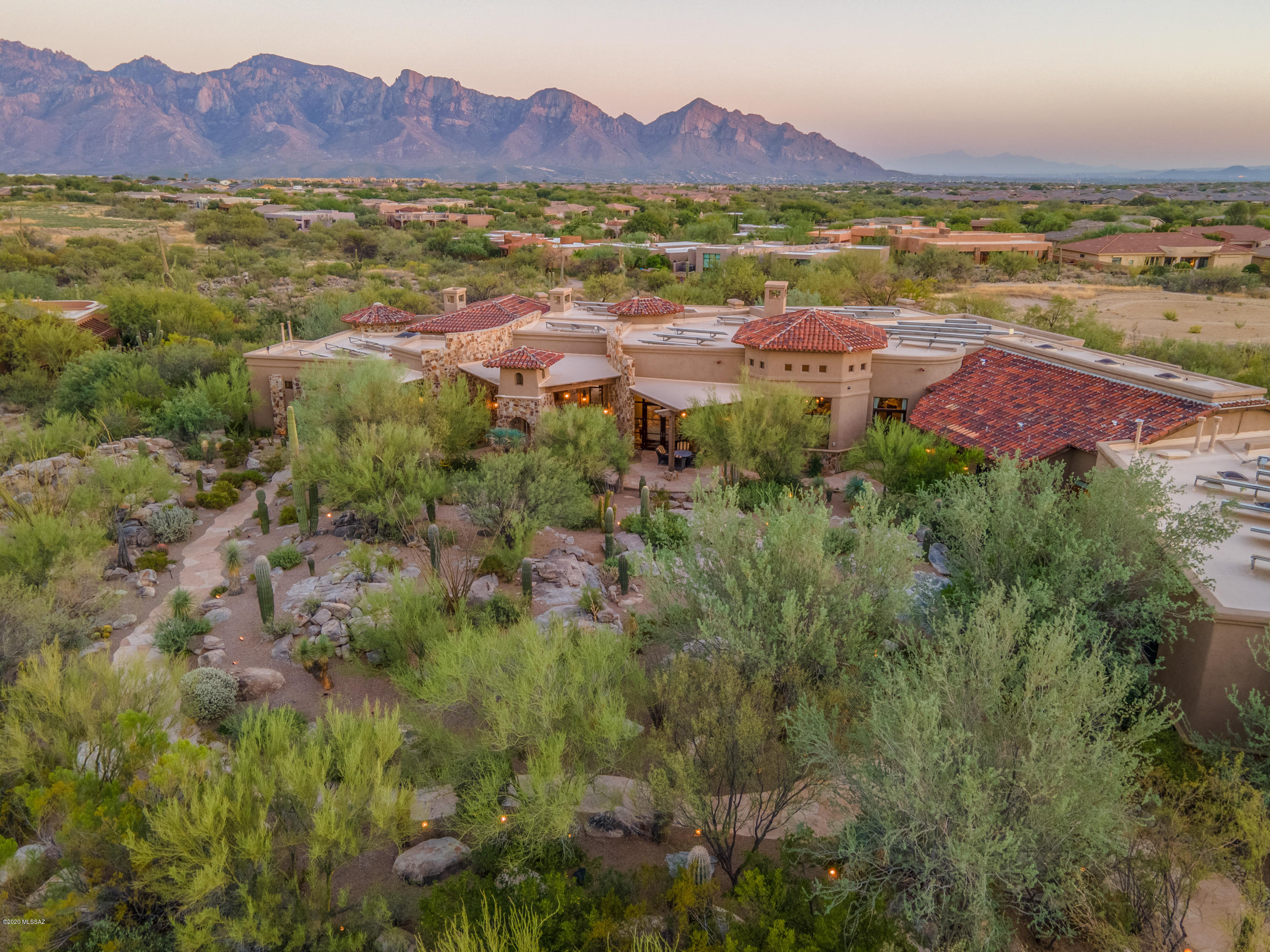 Meander your way to this stunning Romantic Italian Villa partially hidden behind desert & boulders. As you approach the home you are welcomed by a stream of water flowing under the bridge leading you to grand antique front doors. The foyer lavishly surrounded by stone walls, ripple barrel vaulted ceilings lined with bricks and beams. Library/Office features alder wood beam ceilings, wood paneling, curved stone walls and unique parquet pattern wood floors. Spacious master suite  designed with a luminous grey palette inspired by carved Carrara marble fireplace repeated throughout the suite in silk taffetas and velvet furnishings. Mirrored chandeliers, columned canopy bed and antique floors transition you into the the marble covered master bathroom. Solid Carrera marble tub, vanities, floor and walls. 9' circular double shower features mosaic floor and stone paneling.  Roman inspired architecture can be found in every room. Three additional gracious guest suites with private patio areas. Glamours dinning room setting complete with stone curved wall, outdoor patio access, wood floors and distressed beams against painted coffered ceiling.  Grand living room space extends to cozy seating space near one of many fireplaces and full bar for the entertainer. Bar fully stocked with commercial ice maker, microwave, dishwasher, sink and plenty of bar top space for all to gather. An ingenious raised intimate casual secondary dinning area off the living room allows for a full view and easy access to the adjacent temperature controlled wine cellar. The Italian farm house kitchen features a 17' beamed ceiling, clerestory windows, rustic finishes, hand painted glass wall cabinets and a butlers pantry. Elegant book case media center, handcrafted tiles, silk covered furnishings, distressed beams, painted coffered ceilings are just a few luxuries you will find in this incredible home that truly welcomes and inspires. 

Property is presented and sold furnished. List of items not conveying will be provided.  

Home is Solar Powered - Owned Solar Equipment

Matterport Video Tour Available 

Under Documents Tab - Floor Plan is available

Video Coming Soon!