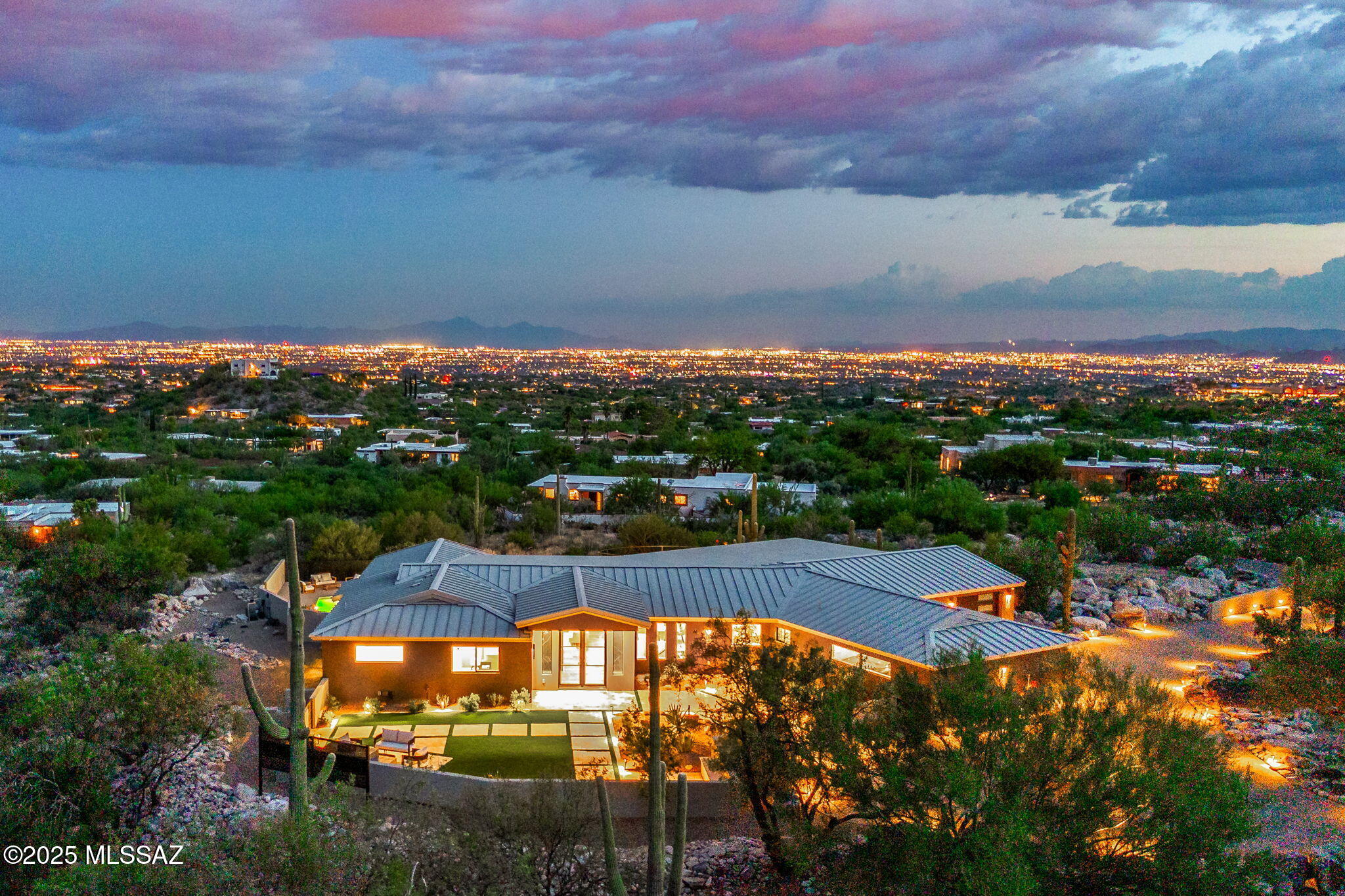 Perched on one of the most spectacular view lots in the Catalina Foothills, this Modern renovated home delivers sleek sophistication and breathtaking 360 degree panoramas. Sweeping city views and spectacular perspective into rugged Finger Rock Canyon. The residence showcases professional design concepts and tangible craftsmanship, with rich hardwood floors and textured layers Thoughtful, diligent renovation has created an elegant, one-of-a-kind home. The gourmet kitchen is outfitted with Thermador appliances, while multiple fireplaces create inviting ambiance. Entertainers delight with large covered patios plus the large living room downstairs. Luxurious Primary Suite w/ private deck overlooking the Tucson Valley. Extensive List of Features available. Owner has AZ Real Estate License.