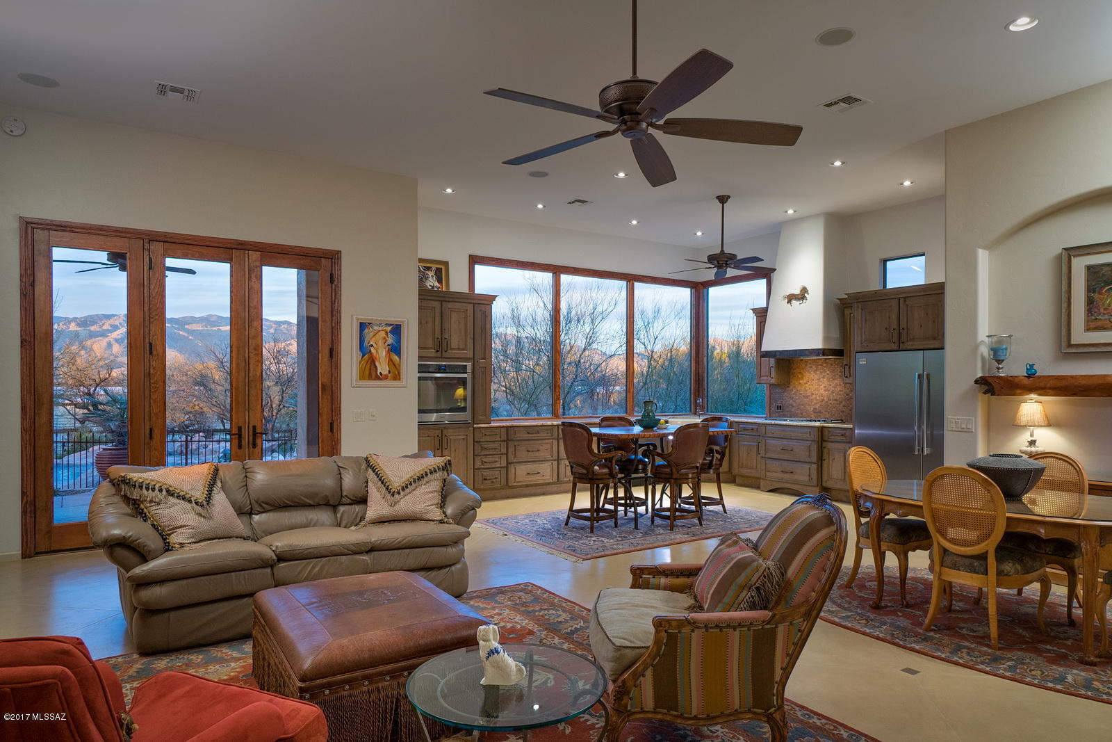 Very private 3,328 sf, 4 bedroom home in the middle of horse country just ½ block from Tucson city limits. Lush mesquite trees and foliage surround this 3.92 acre property with gorgeous panoramic views of Catalina & Rincon Mountains. Five homesite gated community. Castlebrook 4 stall barn plus hay & tack rooms with fenced corral area and 300 yards out back gate to Tanque Verde Creek trails. Kitchen remodeled in 2014 has 16 feet of picture windows (over 6 feet high) capturing Catalina views. Kitchen features walk-in pantry, knotty alder cabinets, farmhouse sink, granite countertops, SS appl, WOLF gas cooktop, Bosch dishwasher, separate freezer & refrigerator. Scored concrete floors, 12’ high ceilings, and remodeled bathrooms. Backyard has flagstone patios, pool, spa with rock water featu