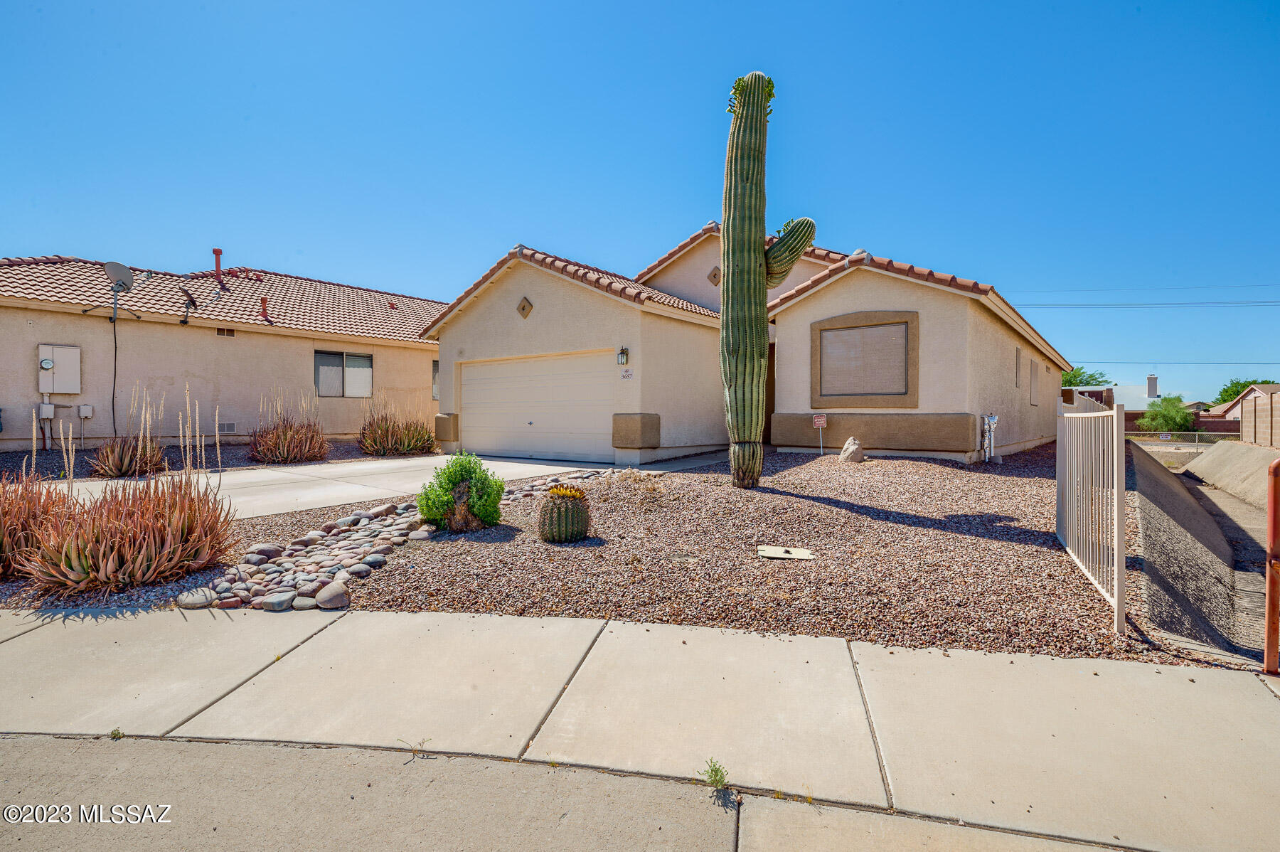 Nestled at the end of a quiet cul-de-sac, this enchanting home offers 3 beds, 2 baths. The large master bedroom overlooks the rear yard, while the master bath boasts a walk-in shower and double sink vanity. The open floorplan features a cook's kitchen with double ovens, a 4-door fridge, and ample counter space. Outside, a pool, covered patio, and built-in outdoor kitchen with Kitchen Aid brand outdoor BBQ, wine cooler, and granite countertops await. With a 2019-installed 20 SEER HVAC system, fully paid solar system, updated insulation, vaulted ceilings, ceramic floors, extra long 2-car garage, smart panel, wired   security, and north-south exposure, passive AND Jacuzzi brand heat pump pool heater, this home is a perfect retreat at the end of the day. All furniture is for sale also.