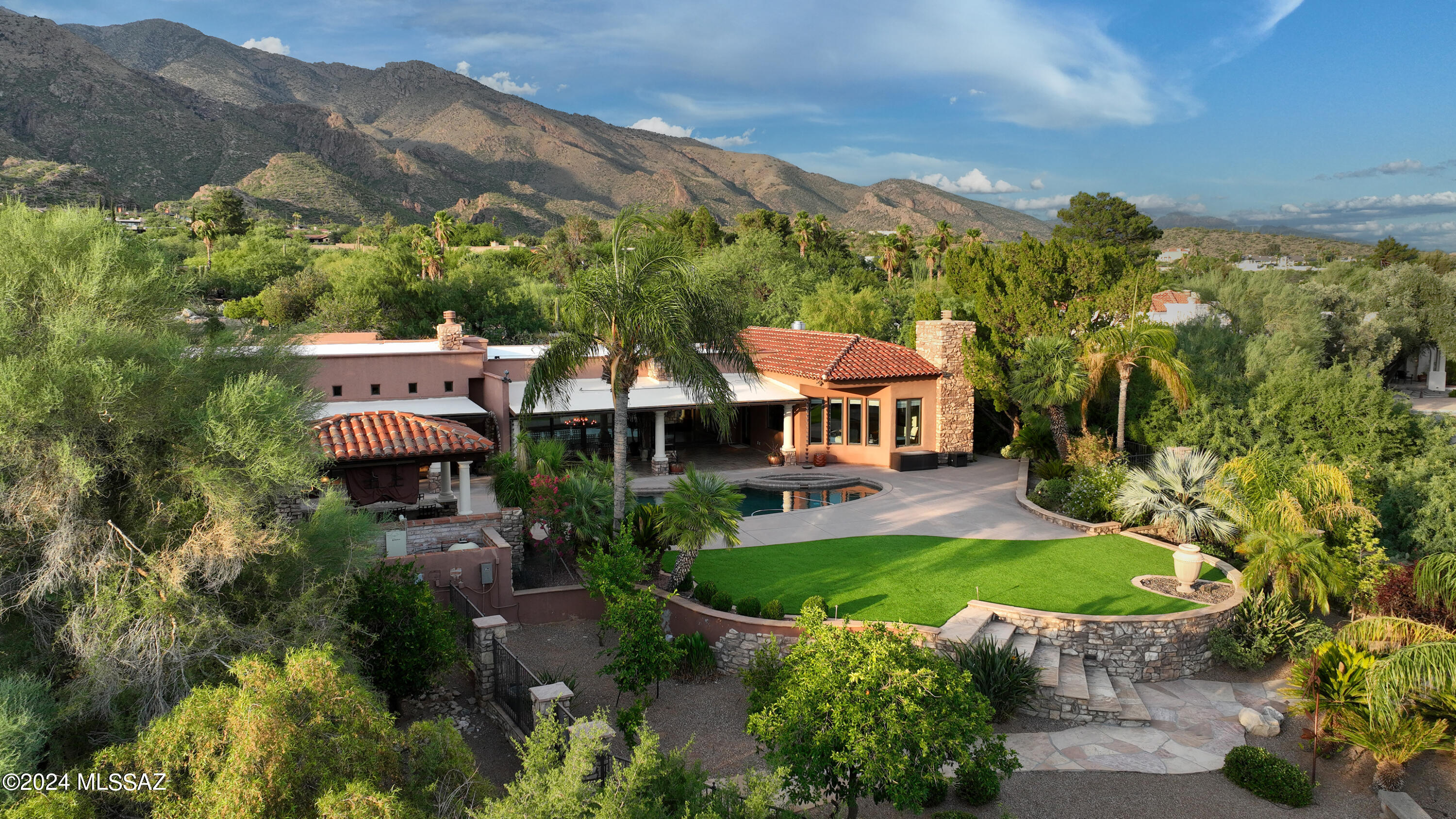 Welcome to 6640 N Los Leones Drive, a masterpiece of luxury living in the prestigious Skyline Country Club Estates. This stunning 4,804 sq. ft. estate, set on a sprawling 1.08-acre lot, features 4 bedrooms and 4 bathrooms and has been meticulously remodeled to blend its timeless Old World Charm with modern elegance. Set in a gated community, this home offers unparalleled city, mountain, and golf course views, making it a true showcase of refined living.

As you approach the grand entrance, you'll be greeted by a captivating cactus water fountain with natural rock features, large boulders with a cascading waterfall, and subtle up-lighting for an enchanting night effect. The custom iron gate and wrought iron front door open to a courtyard adorned with pavers, lighting, Property Video: https://youtu.be/JAyZ5EsPlwY?feature=shared