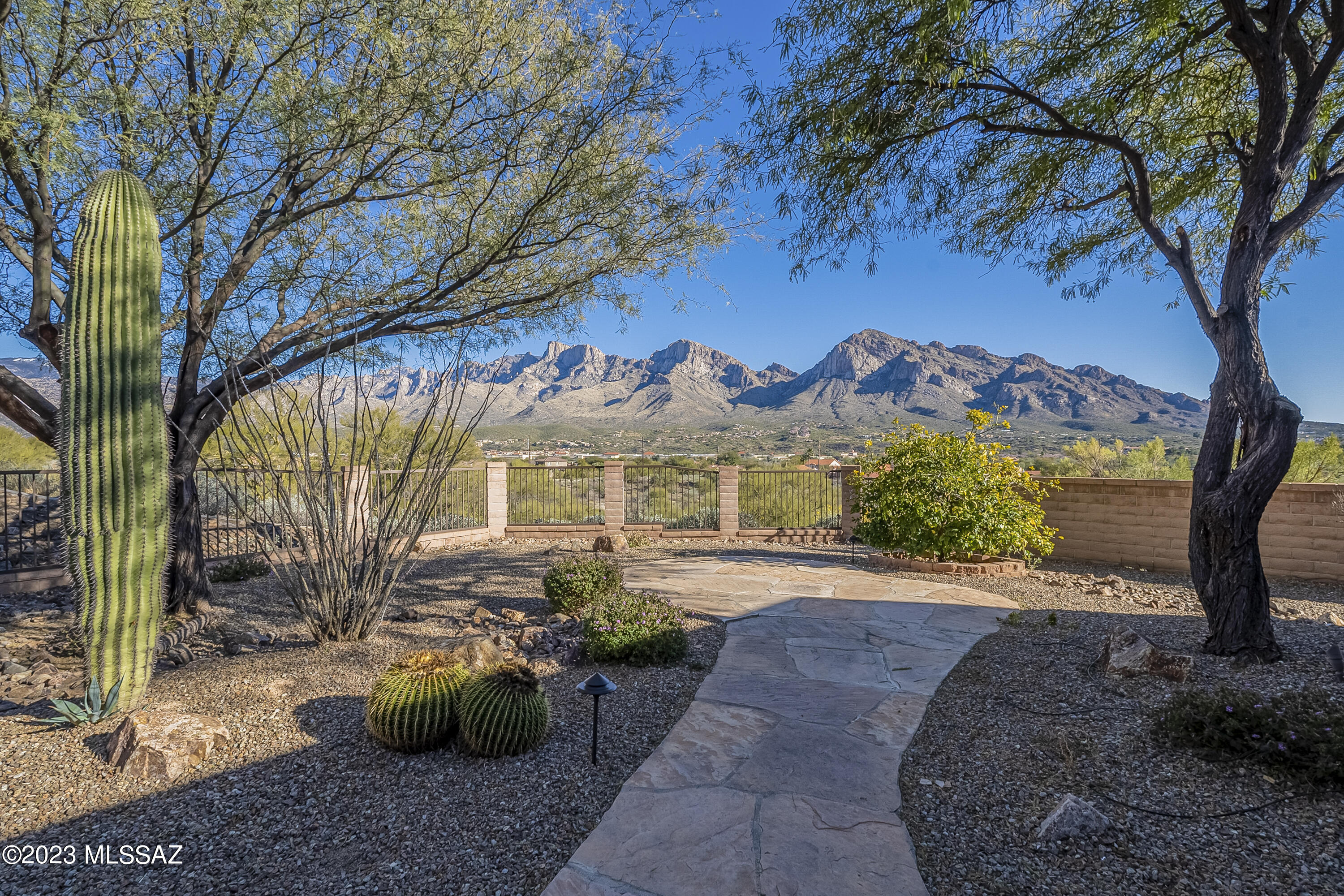 Paradise found in upscale Pusch Ridge Vistas! This Oro Valley stunner features drop dead PANORAMIC MOUNTAIN VIEWS from the east facing backyard. Private lot is at the end of a quiet cul-de-sac. A welcoming courtyard greets you, then enter a beautifully appointed Sombra built home. This kitchen is a chef's dream, with gas cooktop, double ovens and versatile island.  Great Room is open and airy, with natural light streaming through large windows. Owner's Suite is a private retreat with cozy fireplace; bath has massive walk in shower and soaking tub. Also: plank & beam ceilings, knotty alder doors, Trane AC new in 2019. Backyard is perfect for relaxing or entertaining with breathtaking views, flagstone patio and extended covered patio. Ready for your most discerning buyers.