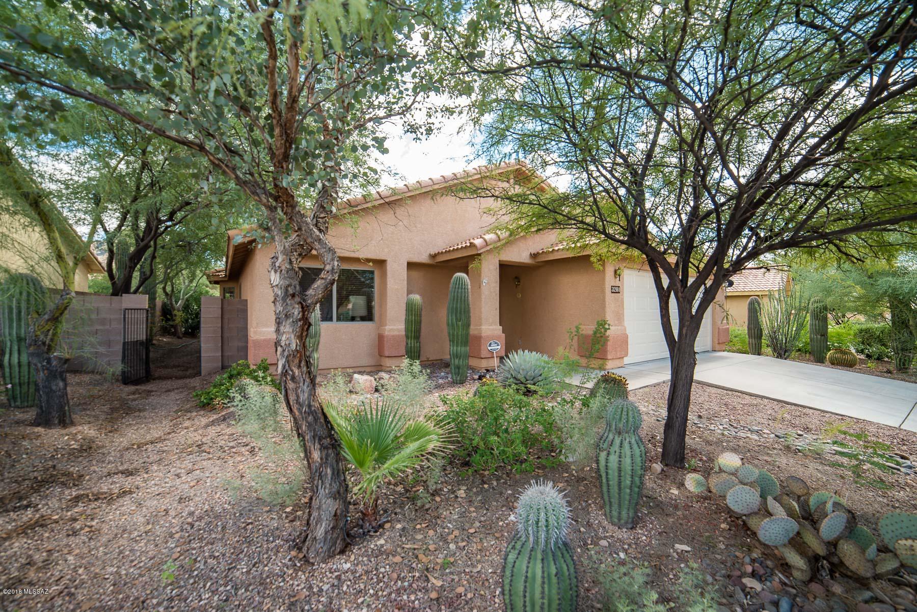 Beautiful home on a large cul-de-sac lot. Great floor plan and fantastic landscaping outside. High vaulted ceilings, executive height cabinets, ceiling fans in every room, extra shelves and storage, wood blinds. Master bathroom has dual sinks and garden tub. Brand new A/C. Yards have beautiful lush desert landscaping with lots of saguaros and many mature trees. Big covered patio out back.