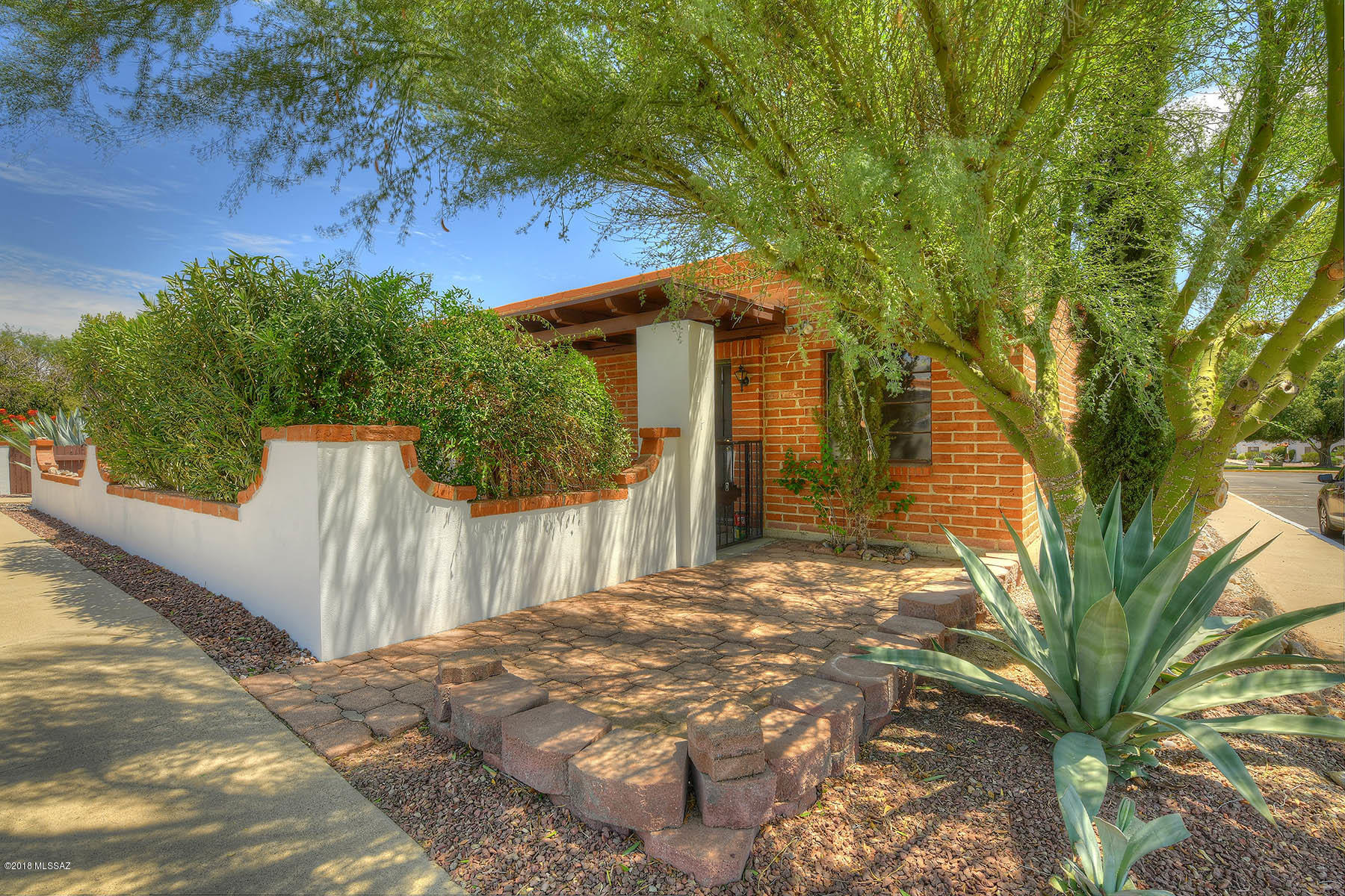 Your very own diamond in the desert, this TWO bedroom villa has it all!  CORNER unit with rich red stone walk-way leading o the pretty front courtyard.  Lots of space in front for desert plantings and pots.  A large mesquite out front adds Arizona charm and shade.  The front patio on this unit offers ultimate privacy with lush landscaping all around.  UPDATED kitchen has new earth-toned counters and new frig.  Warm ceramic tile and fresh paint throughout give the unit a designer feel.  New vanity in the bathroom adds an updated look.  YES-it has the laundry closet, and is close to the neighborhood pool  Walk your dog in the community park and stroll to the farmers market next door to pick up supplies for your evening meal.  A $3000 assessment for NEW HVAC has already been paid! The new HVAC unit will be all yours when installed!  The HOA truly does everything for you in the Villas, so nothing to do but enjoy the desert sun and your new "home away from home" in the Sonoran Desert!  !