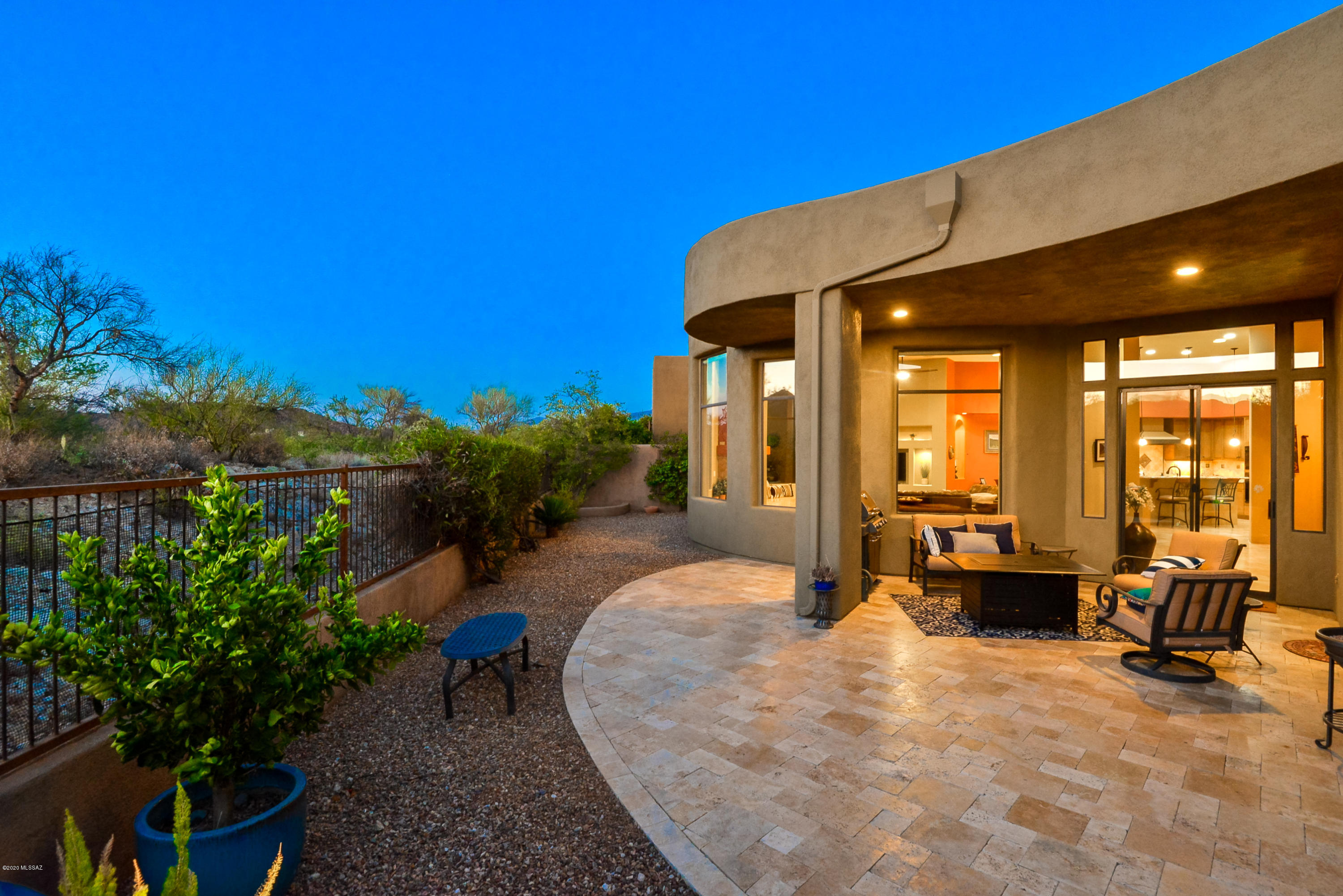 This exquisite Kevin Howard-designed villa nestled in the serene enclave of Stone Village reflects the essence of Tucson living! A tranquil front courtyard and iconic desert/mountain views from a backyard retreat complement this dynamic floorplan. Gorgeous views from the great room, soaring ceilings, and a kiva-inspired fireplace are sure to impress! Designer kitchen featuring granite counters, wine/beverage cooler, gas cooktop, wall ovens, and counter-depth refrigerator. Luxurious owner's suite with private patio entry, lavish ensuite bath, two walk-in closets, and adjoining sitting area/personal sanctuary. Split-bedroom layout includes two guest bedrooms each with attached baths. Attention to detail throughout: plantation shutters, niches, skylights, R/O system, and epoxy garage floor.