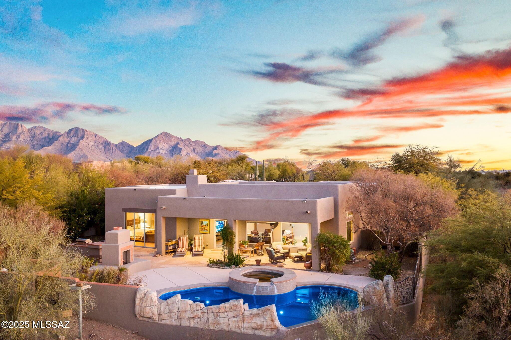 A Masterpiece of Desert Serenity & Luxury
Welcome to a home that feels like a living canvas, where the desert sky paints a new masterpiece each evening. As the sun dips below the horizon, hues of amber, coral, and violet stretch across the sky, reflecting against the rugged peaks in the distance. This tranquil retreat is nestled within the prestigious Tangerine Heights community, offering a harmonious blend of elegance, privacy, and seamless indoor-outdoor living. Inside, the free-flowing floor plan invites light to dance across the expansive great room, where picture windows frame breathtaking desert views. The well-appointed kitchen, adorned with granite countertops, a double oven, and a whole-house water filtration system/softener, is designed for both function and beauty. The luxurious owner's suite showcases the beautiful backyard views from the sliding glass doors that lead to the patio. The en-suite bathroom is a spa-like retreat featuring a dual vanity, oversized walk-in shower, garden tub with picture window, and walk-in closet.
A bonus office space provides the perfect retreat for creativity or productivity, while a new 2024 HVAC system ensures year-round comfort.
Step into your own private sanctuary, where a heated Pebble Tech
pool and spa, built-in BBQ, and flagstone patio create an outdoor haven. The gated courtyard, mature flora & citrus trees, and cascading sunset views complete this breathtaking backdrop an ever-changing portrait of the Sonoran Desert's splendor.

Beyond this oasis, adventure awaits. With hiking and biking trails, golf courses, and pickleball courts just moments away at the Oro Valley Recreation Center, this home offers the perfect balance of tranquility and activity.