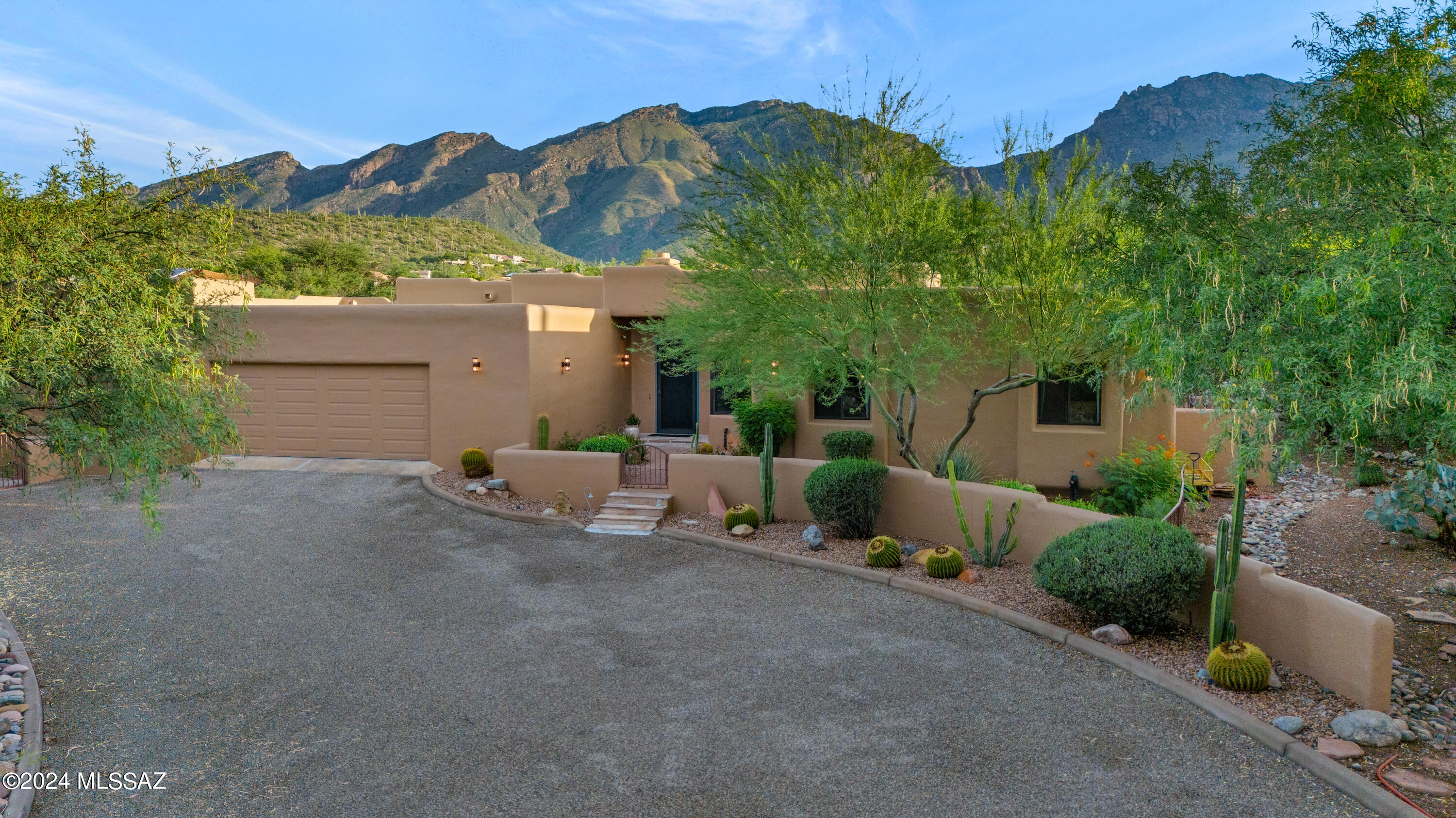 Nestled at the end of a cul-de-sac in popular Cimarron Foothills Estates on a private one-acre homesite with/ extraordinary, unobstructed mountain views. This sprawling, 4100 SF  one-level custom home w/ four bedrooms, four bathrooms, a bonus room, & an office is truly move-in ready. Follow the long driveway to a charming courtyard entry. Inside, you will find an impressive entry w/ high ceilings, abundant natural light, &  a wall of windows to display the mountain views & lush desert landscape outside. Natural accents like wood & stone beautifully complement the neutral color palette throughout the living space. At the heart of the home is a spacious kitchen that effortlessly connects the family room, the large dining area, the breakfast nook, & the outdoor living & dining space.. for ease of living & entertaining. The kitchen is complete with a center island, granite countertops, tile backsplash, double ovens, a warming drawer, &  a view of the backyard & glorious mountains from the kitchen sink. A see-through fireplace warms the family room & dining kitchen/area on cooler winter nights. Adjacent to the kitchen is an oversized laundry room perfect for storage, pantry items, & more. The east wing of the home features a spacious owner's suite, an en-suite guest bedroom that is a mini-owner's suite, two additional bedrooms & a full bath. The owner's suite is a true retreat w/ a sitting area, private access to the patio, his & hers walk-in closets w/ custom built-ins & a luxurious bathroom w/ a double vanity, a tile-surround shower w/ a glass door, & a separate soaking tub. The west wing of the home features an office with custom built-ins & big windows to capture the spectacular views & a large bonus room that can be customized to fit your lifestyle- whether as a playroom, workout room, studio, home theatre, or an additional office. Designed for the best of desert living, the huge backyard is completely walled-in & features a covered patio for outdoor living & dining, an outdoor fireplace, a fenced-in pool area, a fenced-in basketball/sport court, a massive, low-care turf lawn, fruit trees & a separate patio w/ a beautiful fountain & pond. Enjoy Arizona's finest weather in this dream backyard, designed to create an outdoor space you'll love spending time in. The current owners have made this special home even better with upgrades, including whole house exterior paint, backyard renovation with a flagstone patio extension, extensive new rock, removal of grass & addition of new low-care turf, new hvac in 2023, several windows replaced, & more. Convenient location just minutes from Whole Foods, great restaurants, shopping, hiking, biking, world-class golf resorts & country clubs, & Sabino Canyon. 

Rated Arizona's #1 School District several times, the Catalina Foothills School District's schools are high performing. Ventana Vista Elementary, serving the residents of Cimarron Foothills Estates has a Spanish Immersion program. Students go on to Esperero Canyon Middle School where they have extensive visual and performing arts program, continued learning for Spanish Immersion students and Spanish for non-immersion students, high-level math classes, and more. Catalina Foothills High School, provides comprehensive and rigorous academic programs that are recognized nationally for preparing students well for postsecondary education.

Hiking in the area: This home is located minutes from Sabino Canyon Recreaction Area, home to some of the best hiking trails in Tucson. Near this home, there is direct access to several hiking trails from Ventana Canyon to Pima Canyon.

Biking in the area: With the annual Tour de Tucson bike race, Tucson is a biking mecca where amatuer and professional cyclist train. The riverwalk bike path also know as the loop is a 133-mile connected bike path that reaches every corner of the city. In addition to road biking, mountain biking is a popular sport in Tucson.

Golf, Tennis, & Pickleball: This home is located near Ventana Canyon Country Club, Skyline Country Club, & La Paloma Country Club.  Members have access to world-glass golf courses, tennis courts, pickleball, swimming, workout facilities, & social events.