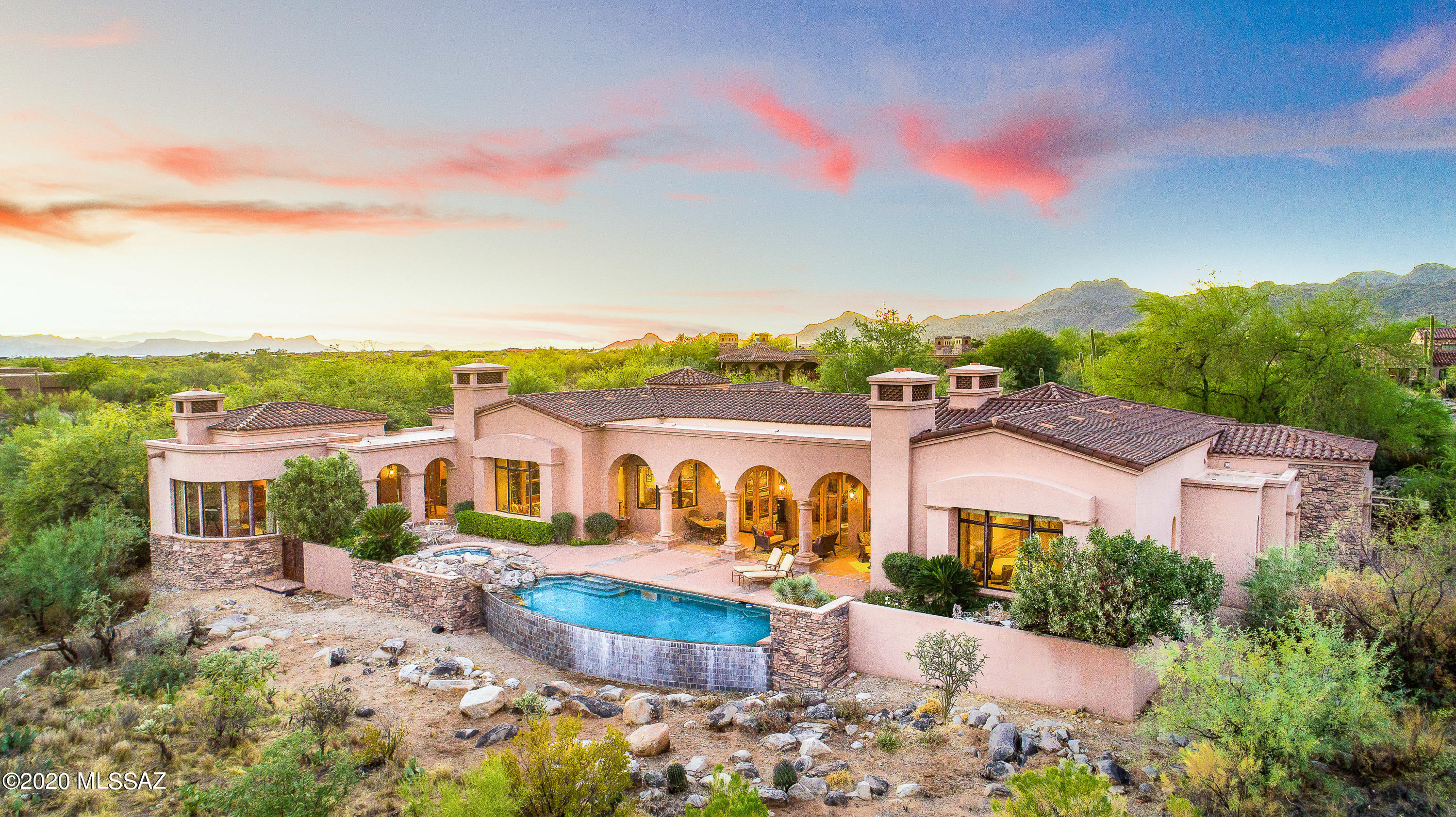 Timeless Mediterranean design inspired by Portugal's classic architecture rich with traditional elements for refined elegance and casual practicality. Furnished luxury Stone Canyon residence with 2-room guest house offers true sanctuary for today's spatial lifestyle reqmts: formal & casual living/dining, library, 2 offices, rec/media, exercise, private guest suites. Panoramic golf & Catalina views! Architecture by Kevin Howard architecture, master builder Jeff Willmeng masonry construction, Lori Carroll, ASID interior design. Inviting elements include Cantera fpls, wood beams, Kashmir slate floors, Alderwood doors, courtyard waterfall, neg-edge pool/spa, lush landscaping, circular drive. Exclusive Stone Canyon Club owned by Arcis Golf. Most breathtaking scenery in Tucson! Membership Req'd. Furnishings excluding select artwork, accessories, and personal items available via separate Bill of Sale. Located close to private Clubhouse and Fitness Center on best street in guard-gated Stone Canyon. Circular drive, 3-car garage, masonry construction and single level with NO interior steps! Privacy and amazing east-facing Catalina Mountain views on Stone Canyon's championship private golf course for the perfect laid-back AZ lifestyle!