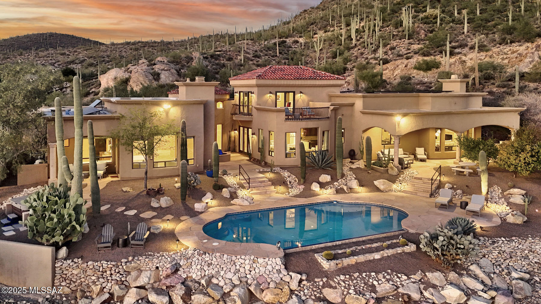 Unmatched Tucson elegance in a prestigious, gated community — The Estates at Starr Pass — high above the city in the Tucson Mountains. Set at the base of Saguaro National Park, this exceptional 4,995 sq. ft. luxury residence sits on 3.3 acres of pristine, saguaro-studded desert, offering unparalleled privacy and sweeping views of Tucson's skyline and mountain ranges.  Blending modern Southwest design with elegant contemporary functionality, this home exudes warmth, sophistication, and comfort.  Step inside to discover soaring ceilings, expansive living spaces, walls of glass, and an open floor plan ideal for entertaining. The dramatic foyer is the center of the home. Just off the foyer, the spacious living room features a formal dining area, and a coffee bar/wet bar combo, providing inviting spaces to relax or host with style. The comfortable family room, open to the kitchen, offers a cantera fireplace, numerous built-ins, and a light & bright breakfast area. The gourmet chef's kitchen is the heart of the home, featuring custom cabinetry, granite countertops, a large island with a prep sink, and top-tier stainless steel appliances including a professional-grade range with a pot filler and double dishwashers. The split floor plan ensures privacy, offering four spacious bedrooms, each with its own en-suite bath.  The primary suite is a serene retreat with stunning views, a fireplace, access to a private covered patio with a hot tub, a spa-inspired bathroom with dual vanities, and a generous walk-in closet. The office features custom cabinetry, and the adjacent den/office could be a 5th bedroom.  Upstairs, an impressive guest suite offers a private balcony with panoramic views, perfect for visitors or extended family.  Step outdoors to your resort-style backyard, complete with covered patios, extensive use of flagstone pavers, a sparkling pool, and a built-in BBQ, all framed by Tucson's spectacular sunrises & sunsets.  Every luxury detail has been considered, including fully owned solar, whole-home water softener, reverse osmosis system, automatic window coverings, and gas fireplaces throughout. The three-car garage provides ample room for vehicles and storage, including a mud room.  Located just minutes from downtown Tucson, you'll enjoy quick access to fine dining, shopping, and entertainment. Hiking trails begin just beyond your doorstep, and Starr Pass Golf Club is a short golf cart ride away.  Experience the perfect balance of secluded desert living and urban convenience in this truly extraordinary home.  Schedule your private tour today and discover the best of Tucson luxury living!