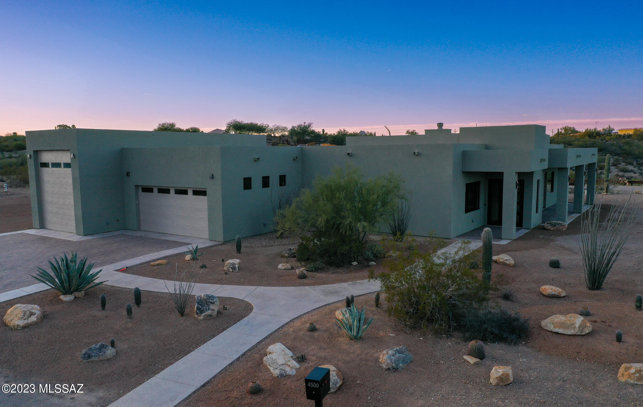 Many upgrades/extras RV garage + cabinets & storage throughout. Custom contemporary new build 2,907 SF located in private  66-acre gated conservation comm'ty with 20 x 1+acre homesites.  Chef's kitchen includes lg island, Thermador smart appliances, gas range, triple ovens, french door fridge, large w/i pantry, butler's w 2nd fridge & Tucson Mtn views. Panoramic east facing city light & Catalina Mtn views from large windows/porch & courtyard.  Enjoy many saguaros with mature native desert landscaping.  Nature abounds in 30+acres of natural areas set aside for LAS ROCAS.  12' ceilings in huge great room w gas f/p.  Linear f/p in primary b/r with floating bed concept.  No need to leave the primary suite !  8' doors. Prewired for your entertaining needs inside & out.  Nothing to do but move