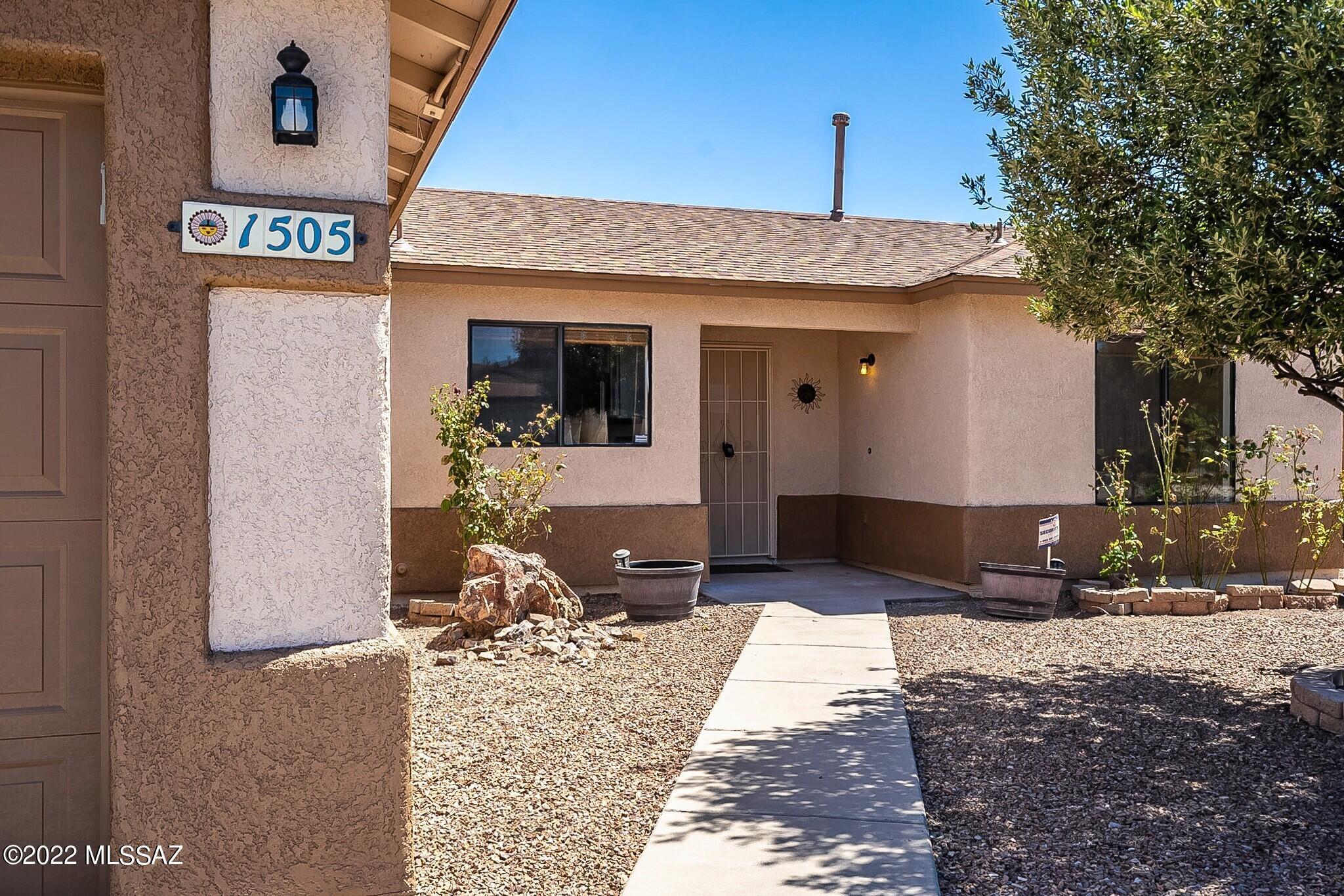 LOCATION, LOCATION, LOCATION is what this home has to offer! 3 BR/2 BA home sits in a desirable neighborhood in Midvale Park. Home has new exterior and interior paint. Appliances including Range, Microwave, Dishwasher and Refrigerator come with home! Beautiful tile flooring throughout the home. Room for plenty of family gatherings & a kitchen with plenty of counter space & cabinets for storage. Separate formal living and dining room. Split bedroom floor plan, vaulted ceilings, large Master BR, ceiling fans in every BR. Spacious 2-car garage. Low care front landscaping. BIG backyard with brick wall, pet ready with kennels. SAVE ON YOUR ELECTRIC BILLS!! 19 Solar Panels installed! Home is close  to Tucson Spectrum shopping center, restaurants, fitness center, theater and I-19! A must see!