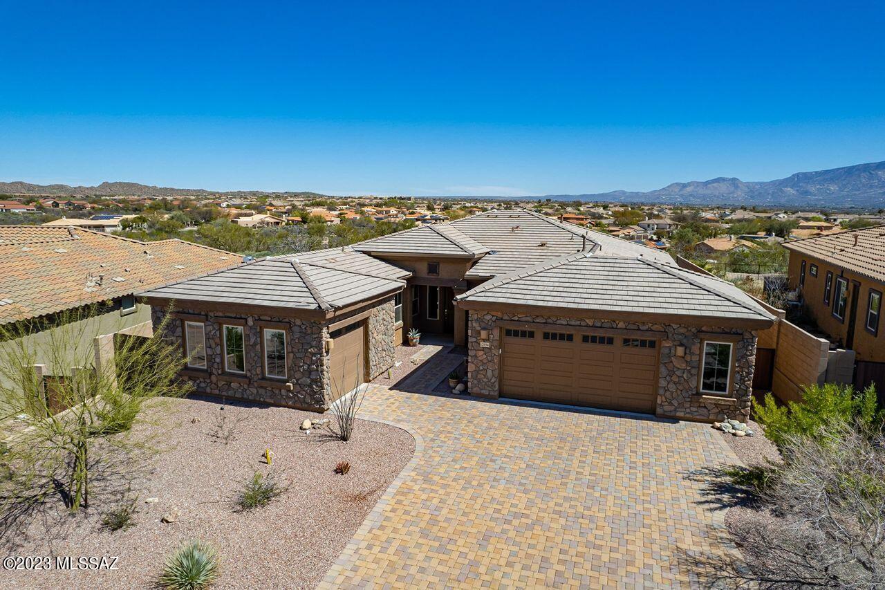 Nestled in the heart of Oro Valley this gorgeous 3 bdrm + Den/3 bath 2018 Lennar built home backs up to open space. With Split bedroom floor plan, the large Primary Suite includes 2 walk-in closets, walk in shower, large dual sink vanity. Extra large laundry room & storage. Expansive 10 ft. ceilings, open concept great room, gourmet kitchen with SS appliances incl. 2 ovens, a large granite island, and a walk in pantry, plus additional dining room; this home is perfect for entertaining. Experience the blue AZ skies and views of both the Catalina & Tortolita Mts from the covered patio; a perfect retreat for morning coffee or a glass of wine. Just a short stroll to the private entrance of the HOA-owned Hohokam Park. Plenty of parking w/both double and single car garage. The 2 car garage is an extended width Garage. There is also an additional single car garage for a total of 3.