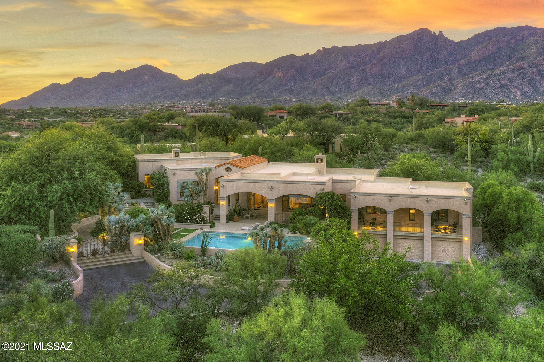 Dramatic Arizona contemporary style home with amazing guest house situated on very private 1.39 acres w/city & mtn views in prestigious gated Catalina Foothills Est #10. Beautiful wrought iron front entry gate invites you into this lushly landscaped front courtyard. Foyer entry w/stunning custom doors, cantera natural stone flrs thruout, exquisite living rm w/high ceilings, walls of windows to capture the mtn views, elegant fireplace, formal dining rm, gourmet island kitch w/granite countertops, gas stove top, SubZero, lovely brkfst area open to family rm w/frplc, 3 bdrms, 2 studys and 5 ba in main house 5649 sqft, 3 car gar + guest house 642 sqft w/living area, frplc, kitchenette & bath. Fab bkyd w/cov patio, pool, spa, turf, BBQ, lush vegetation, fruit trees, Dist 16 & views, views.