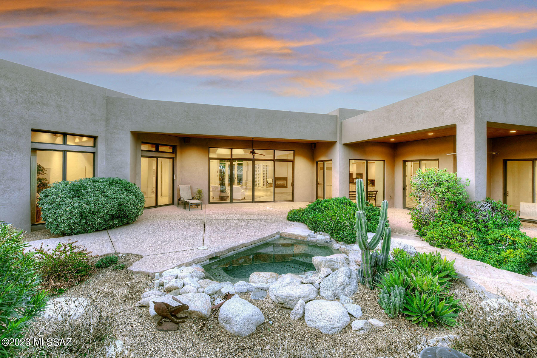 Ron Robinette custom built stunner in sought after exclusive guard gated Ventana Country Club Estates. Fabulous mountain views! Enter to enclosed courtyard with exposed aggregate concrete, flagstone, decorative gravel, manicured mature trees & landscaping. Glass front door & floor to ceiling windows bring the outside in. Lots of natural light in great room, kitchen & dining area; all clad in travertine with birch cabinetry & built ins. Kitchen appointments will suit your inner foodie with 3-sided fireplace, Dacor gas cooktop, Vent-a-hood exhaust, Sub Zero fridge/freezer, Miele dishwasher, 2 sinks with disposals, drink fridge, reverse osmosis water system, granite counters & backsplash. Great room boasts amazing Catalina views through 6 large windows with wood beams & wood ceiling SEE MORE Great room boasts amazing Catalina views through 6 large windows with massive wood beams and wood clad ceilings that extend out to the covered patios. Walled and terraced backyard is ringed in mature trees & well thought out landscaping creating privacy for BBQing at the outdoor kitchen, soaking in the spa with state-of-the-art variable speed pumps and new Pentair spa control unit or sitting peacefully under one of the shaded areas. Split floor plan features a large den or office & the primary suite on one side with more gorgeous views. Primary bath with walk-in shower, two separate commodes, two separate vanities as well as dressing area with entire wall of birch built in cabinets, drawers & well lit counter space & mirror + large walk-in closet. Split plan boasts two guest rooms, each with dedicated baths & walk in closets, as well as a 3rd guest room (or office) & powder room. This wing of the house has a dedicated laundry room with folding area, utility sink & storage cabinets. Travertine throughout (only carpet in primary bedroom). Wonderful curves & angles with spectacular lighting, this is a Ron Robinette one-of-a-kind custom design. Full house high efficiency air cleaner/ filtration system. Plus... whole home Kinetico water softener & water filtration system. XL pristine 3-car garage with attached storage rooms & work bench space. All this fabulous square footage is kept comfortable by 3 separate newer HVAC units. New hot water heater, roof just recoated, all copper pipes. Original owner. Home has been cared for impeccably. Pride of ownership shines! District 16 schools, close to Sabino Canyon, restaurants & shopping + just steps to all Ventana Country Club has to offer. Unbeatable location & bold architecture, this is a home you won't want to miss.