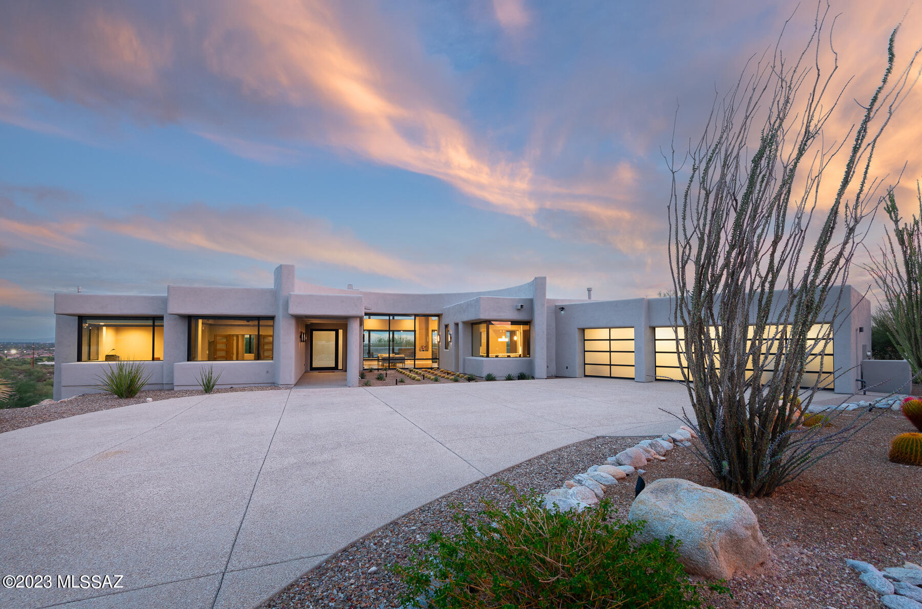 Completely renovated desert contemporary custom home designed by renowned architect Kevin Howard in gated Bellas Catalinas. Located in the heart of the Catalina Foothills, this elevated, one-acre premium lot at the end of a cul-de-sac delivers extraordinary views & privacy coupled with thoughtful design & flawless execution. An exposed aggregate driveway & expansive motor court lead to a custom glass pivot front door. The dramatic great room w/ a formal dining area has soaring ceilings, a modern fireplace  & walls of windows that fill the space w/ natural light. Ten-foot sliding glass door seamlessly connects the covered back patio, providing a protected outdoor living & dining room. Enjoy the twinkling city lights w/ panoramic views of the valley. Perfectly situated modern, sleek CONT.. .....kitchen with a center island and breakfast bar opens to a great room and family room. Upgraded features include Quartz counters, Brookhaven cabinetry, Sub-Zero and Wolf appliances, glass backsplash, prep sink, Butler's pantry, and a wine refrigeratorwith plenty of counter space, cabinets, and storage in this kitchen. The breakfast nook with a corner window captures unobstructed views of the Catalina Mountains. The cozy family room off of the kitchen leads to the back patio and the Lynx BBQ. Open, split bedroom floor plan offers efficient use of space with refined finishes, including porcelain tile throughout, custom rift-cut oak doors, Millard and Western windows, LED lights, Legrand switches/plugs, East wing of the home: Private owner's suite with views to the east, a dual sink vanity, modern soaking tub, large shower and a huge closet complete with custom built-ins including a center island with dresser drawers. The oversized bonus room, currently an office and workout room, has exceptional Catalina Mountain views and a hall bath, creating the potential for a fourth bedroom.  The home's west wing has two guest suites and a hall guest bathroom with tub and shower. Large laundry room with a sink and extra storage finished with the same high-quality materials as the rest of the home. Professionally designed low-care backyard with two elevated viewing decks, modern gas fire feature, custom water feature, and turf.  Pristine three-car garage covered in epoxy, custom storage cabinets, extra large storage closet, and metal and glass garage doors. NEW BOSCH HVAC SYSTEM INSTALLED IN 2022-BOTH UNITS.  Minutes to the University of Arizona, downtown Tucson, St. Phillips Plaza, world-class golf resorts, country clubs, shopping, and restaurants. Easily access to the loop, Tucson's 131-mile connected bike path.