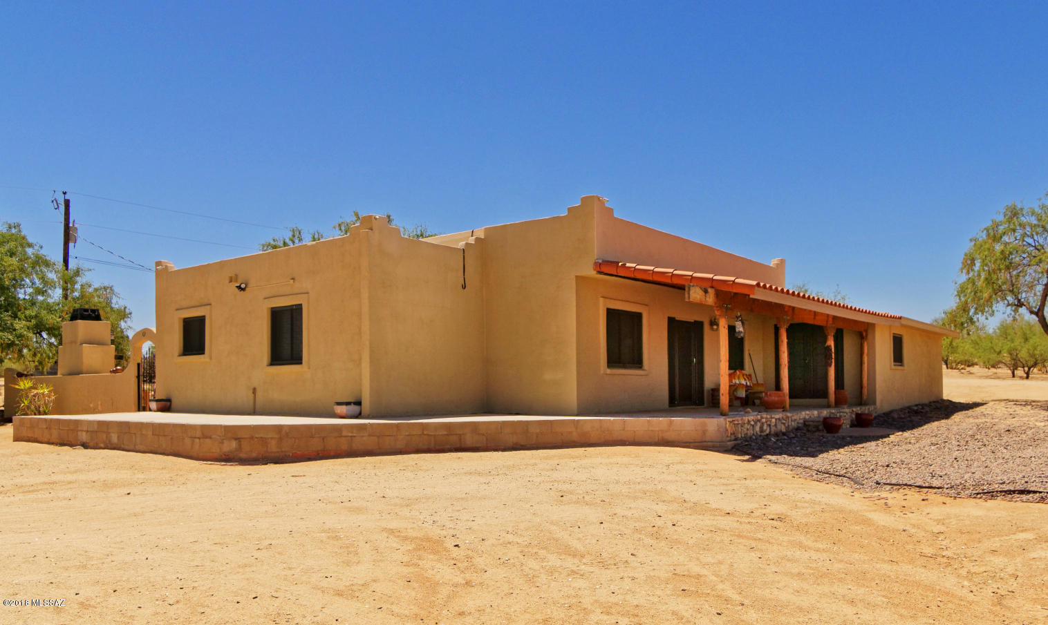 Want wide open spaces? Here's a gem! Custom Ranch style home shining in the desert. Boasting one of the most handsome lots in Valley View Acres. 4.16 acres to be accurate! Custom built cabinets throughout the updated kitchen and 120 square foot cellar. This single story, 3 bedroom, 2 bathroom has an additional room that could be an office or easily transitioned into another bedroom. Bathrooms are very roomy. Family room has custom built in shelving for entertainment devices and a cozy fireplace to boot! Beautiful, large courtyard/patio has an impressive fireplace and outdoor kitchen. Property comes with 1 year home warranty. Don't miss out. This is a MUST see property!