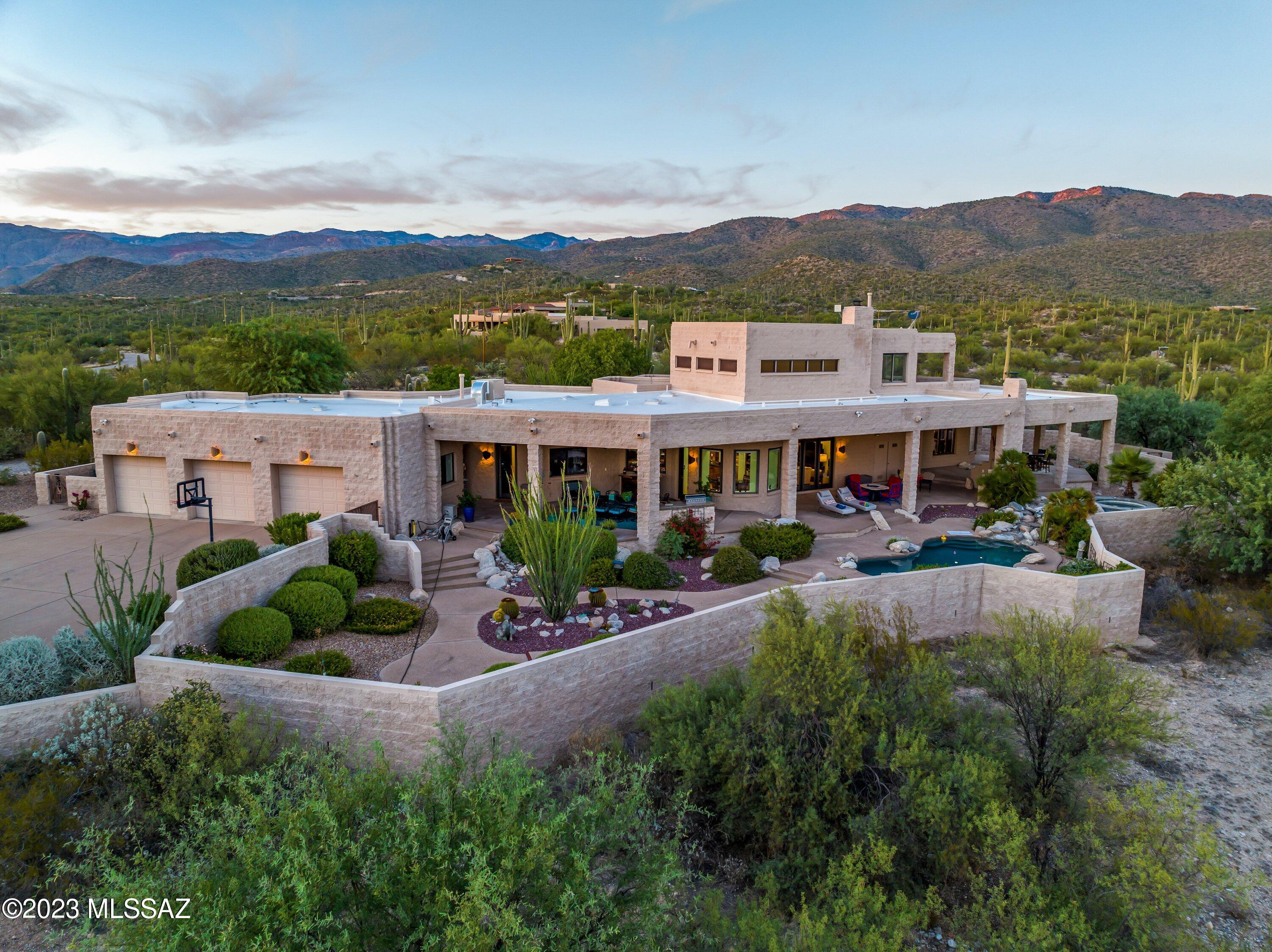 Introducing a Spectacular Ron Robinette Luxury Estate in the Heart of La Cebadilla
Nestled amidst the captivating beauty of La Cebadilla's natural desert landscape and majestic mountain vistas, this exceptional 4-bedroom residence, with the option to use a bonus room as a 5th bedroom, offers an unparalleled living experience. Boasting 4203 square feet of exquisite design and craftsmanship, this sprawling 6-acre horse property is a haven for those seeking both luxury and tranquility.
Upon entering the private gate, you'll be greeted by the grandeur of 22' ceilings, creating an inviting and open ambiance throughout. The home's interior is bathed in natural light, thanks to strategically placed windows that frame the awe-inspiring views, making every day here a breathtaking experience. The heart of this magnificent estate is undoubtedly the massive gourmet kitchen, complete with a cozy breakfast room. It's a chef's dream, featuring top-of-the-line appliances, ample counter space, and custom cabinetry. Whether you're preparing a feast for guests or enjoying a quiet family meal, this kitchen will undoubtedly inspire culinary creativity.
The inviting living area, complete with a charming fireplace, is the perfect spot to unwind and take in the surrounding beauty. Imagine cozying up with a good book while the desert sunset paints the sky with a warm, golden hue.
The first-floor master suite is a true retreat, offering a serene sanctuary with its own fireplace and a wall of windows to wake up to those breathtaking views each morning. The master bathroom is equally impressive, with dual sink areas, a beautifully tiled shower, and luxurious finishes that enhance your daily routine.
Upstairs, a balcony beckons you to embrace 360-degree views of the picturesque landscape. It's an ideal place for stargazing or simply savoring the beauty of the day.
The professionally landscaped backyard is a paradise of its own, featuring a stunning pool and spa, a built-in barbecue area, an outdoor fireplace for cool desert evenings, and an outdoor shower for added convenience. Entertaining guests or simply enjoying outdoor living has never been more delightful.
For those with equestrian interests, this property includes a fully equipped horse arena, a two-stall barn with turnouts, a tack room, and hay storage. Your horses will have their own slice of heaven to enjoy.
Additionally, the oversized 3-car garage provides ample space for your vehicles and includes storage options and a convenient workbench.
This exceptional La Cebadilla estate redefines luxury living, offering the perfect blend of modern amenities, natural beauty, and equestrian elegance. It's not just a home; it's a lifestyle. Come experience the extraordinary and make this magnificent property your own. Contact us today to schedule a private tour and discover the limitless possibilities that await in this desert oasis.