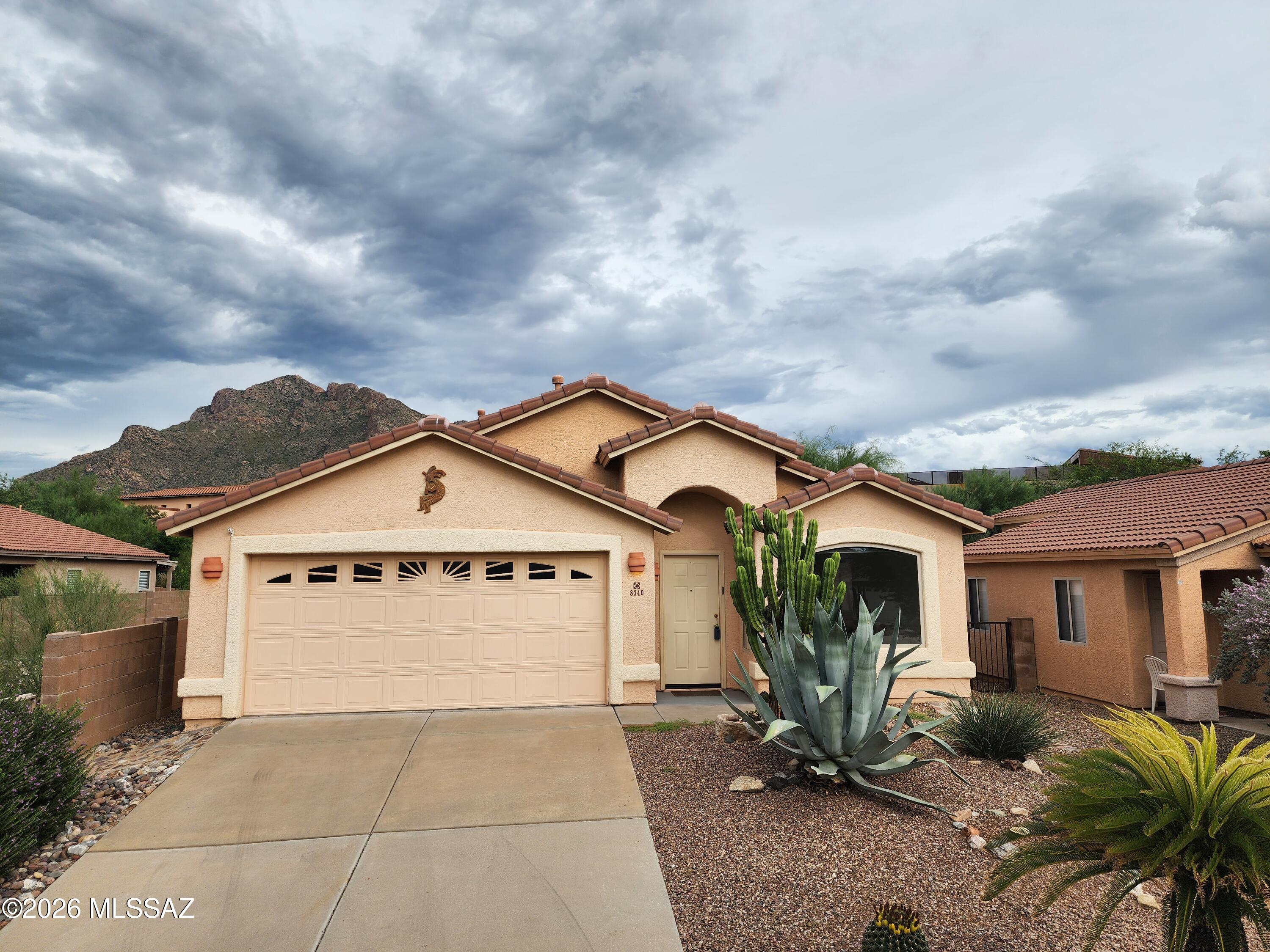 Make this peaceful, picturesque home in Oro Valley your own!
Spacious 4-bedroom, 2 Bathroom home on a quiet cul-de-sac street is also conveniently located near grocery, dining, retail, lifestyle & entertainment hubs. Exclusive shopping, top Amphitheater School District, great medical and hospital care, Catalina State Park and Coronado National Forest for hiking and recreating, Golf opportunities surround, Oro Valley's renowned municipal parks have ball fields, hiking and biking paths, public aquatic center, even an archery facility and skatepark!
Well-maintained streets and sidewalks. Front door entrance opens into a high-ceiling living room large enough to be living room and formal dining area. Sensible mix of ceramic tile and comfortable carpet. Open layout allows flexibility of use, Home perfect for cooking, dining, hosting and hanging out. Kitchen features prep and serving island, dual sink, side-by-side refrigerator gas range, built-in microwave/range hood.
Gas fireplaces in great room and primary bedroom imbue calm evening ambience. The primary bedroom's picture windows offer views of stunning cloud color over Pusch Ridge during sunset. Primary bathroom suite has both stand-up shower, and a wide soaking tub, also dual vanities and walk-in closet
Back yard invites space for planting and outdoor enjoyment with hookup for natural gas grill.  The front two-car garage is fully outfitted with workbench, utility sink and walls of cabinetry that allow for neat organized storage and workspace.  Laundry room includes reliable Maytag washer and dryer and overhead storage.