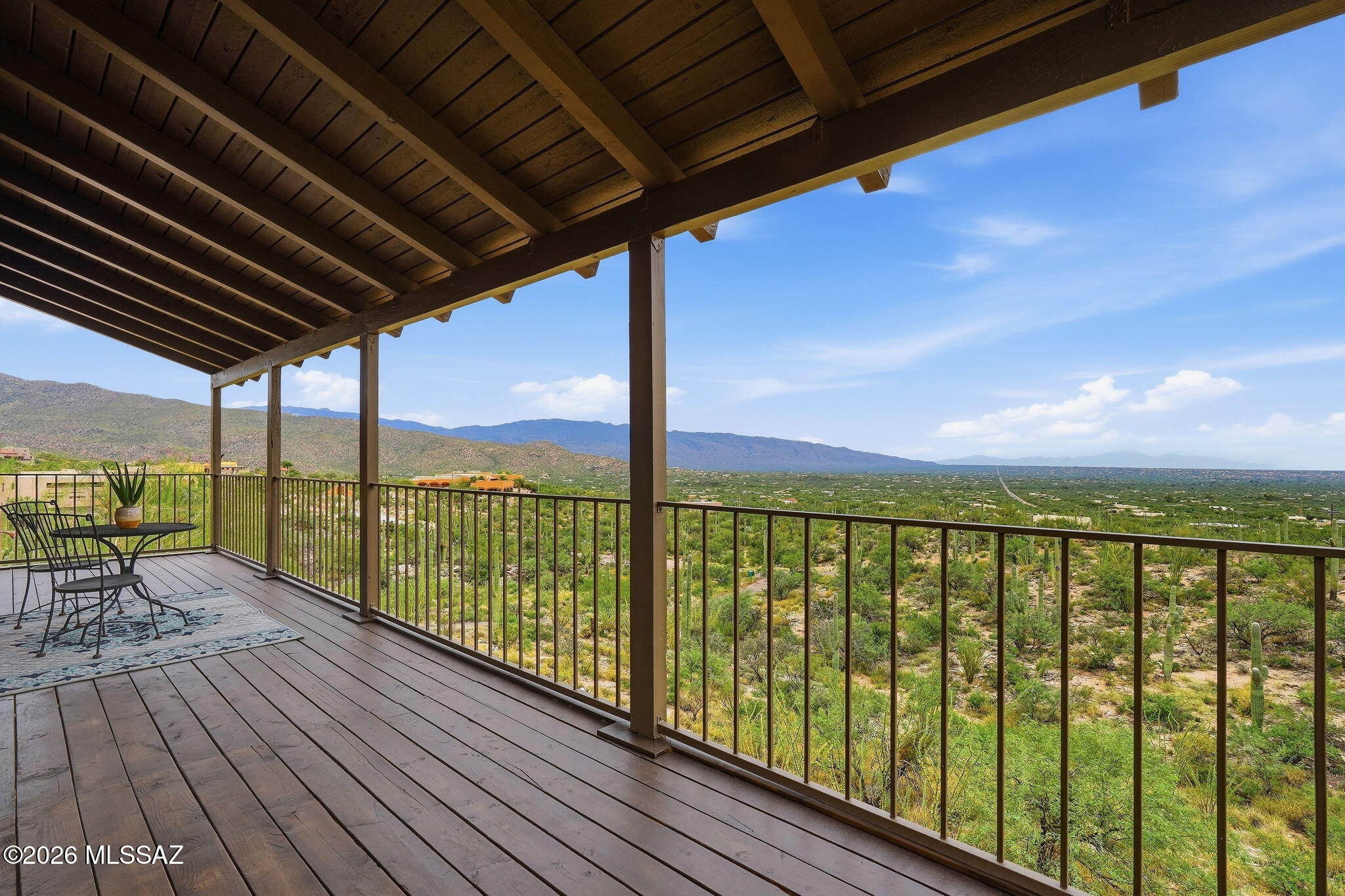 The inviting two-story home showcases classic Southwest character with Saltillo tile throughout, exposed wood beams, soaring ceilings, and expansive windows that bring the spectacular surroundings indoors. Step outside onto the covered second-story balcony and take in breathtaking views of the mountains, city lights, and desert sunsets. Inside, you'll find 3 bedrooms and 2 bathrooms, along with new carpet, fresh exterior paint, and two newer AC units for year-round comfort. A spacious 2-car garage with additional loft storage provides plenty of room for vehicles. With its generous acreage, unforgettable views, mature desert landscape, and authentic Southwest style, this property offers a rare opportunity to enjoy privacy, space, and the beauty of the Tanque Verde Valley-- all just minutes from Tucson amenities and the road to Mt. Lemmon. Come experience the views and discover what makes this desert retreat truly special!