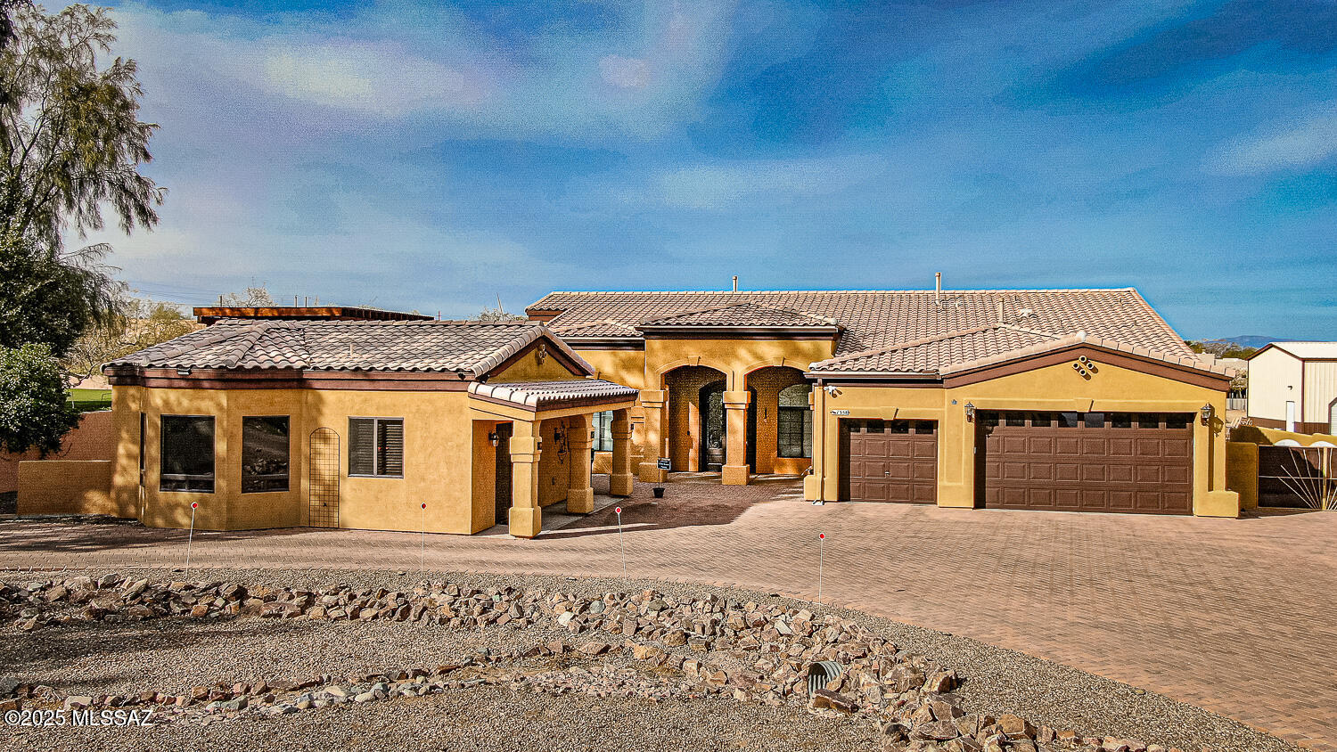 Step into the extraordinary  RESORT-STYLE LIVING with this stunning home, complete with a CASITA and sparkling POOL, nestled on a spacious lot of nearly an ACRE in Mesquite Heights - all WITHOUT the constraints of an HOA! This home exudes impeccable taste, offering an effortless flow throughout its beautifully laid-out interiors. The Great room, bathed in a refreshing palette of light, showcases a cozy gas fireplace that seamlessly merges into the beautiful kitchen. Here, you'll find gorgeous  granite countertops, a wealth of cabinetry, and a breakfast bar and nook - all complemented by top-tier, stainless steel GE Profile appliances acquired as recently as 2023! The separate formal dining area is ideal for hosting gatherings. The expansive Owner's suite is a sanctuary in itself, granting direct access to the backyard and a lavish en-suite bathroom featuring dual sinks and a spacious, tiled walk-in shower. The smart split floor plan also includes two extra bedrooms, a guest bathroom, and a versatile den that can effortlessly double as a media room or home office. Live life to the fullest in the sprawling backyard oasis. It features a shimmering pool with a shallow lounging area, Gazebo, a porch with rolling screens, and plenty and plenty of room to spare. The Casita, an extension of this home, is an inviting retreat for your guests, complete with an equipped kitchen, living room, bedroom, a walk-in closet with laundry facilities, and a bathroom with a walk-in shower. It even opens up to a private, turfed yard, providing the perfect nook for relaxation. 3 Car garage and RV parking allowed. This home doesn't stop impressing, with its bonus features like Wi-Fi enabled thermostats, a recently installed custom iron front door, a water softener system, contemporary light fixtures, and a paved driveway. Plus, it ensures your peace of mind with an alarm system (cameras excluded). Overall, this fantastic home is ideally situated close to shopping areas and provides convenient access to I-19. A remarkable blend of luxury and comfort, this home truly promises an exceptional lifestyle!