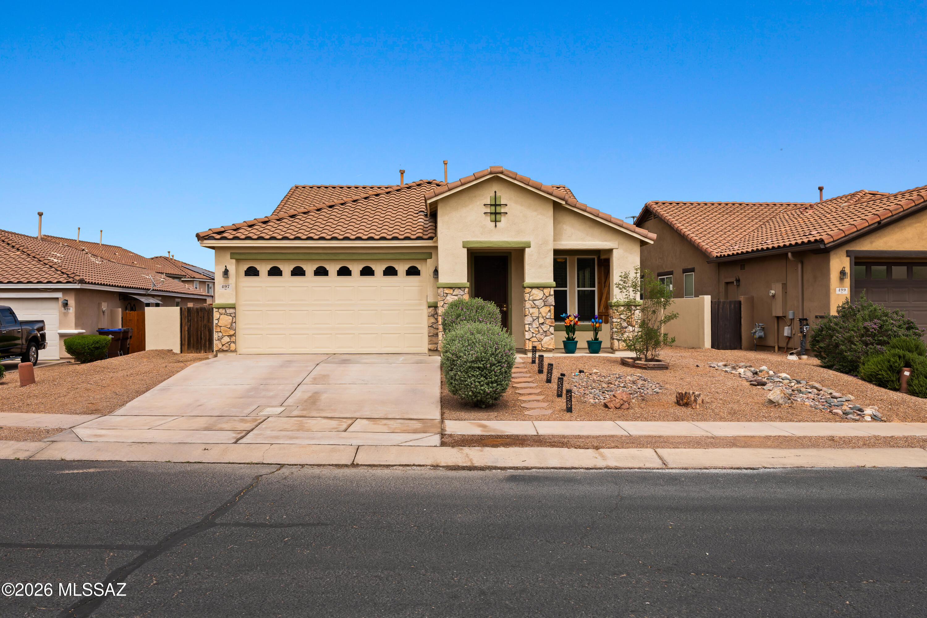 Range Price $320,000-$335,000 Beautiful single story home in Rancho Sahuarita offering 1,900 sq ft of thoughtfully updated living space. Enjoy wide plank tile flooring throughout the entire home and a freshly painted interior and exterior in a neutral palette. The home features a brand new energy efficient HVAC system, spacious bedrooms each with walk in closets, and a versatile flex room perfect for an office or playroom. The updated fireplace adds a modern touch to the main living area. Step outside to a backyard with a covered patio and flagstone pavers, ideal for relaxing or entertaining. Located in the Rancho Sahuarita where residents enjoy resort style amenities including pools, splash park, fitness center, clubhouse, parks, and miles of walking trails, plus access to Sahuarita Lake!