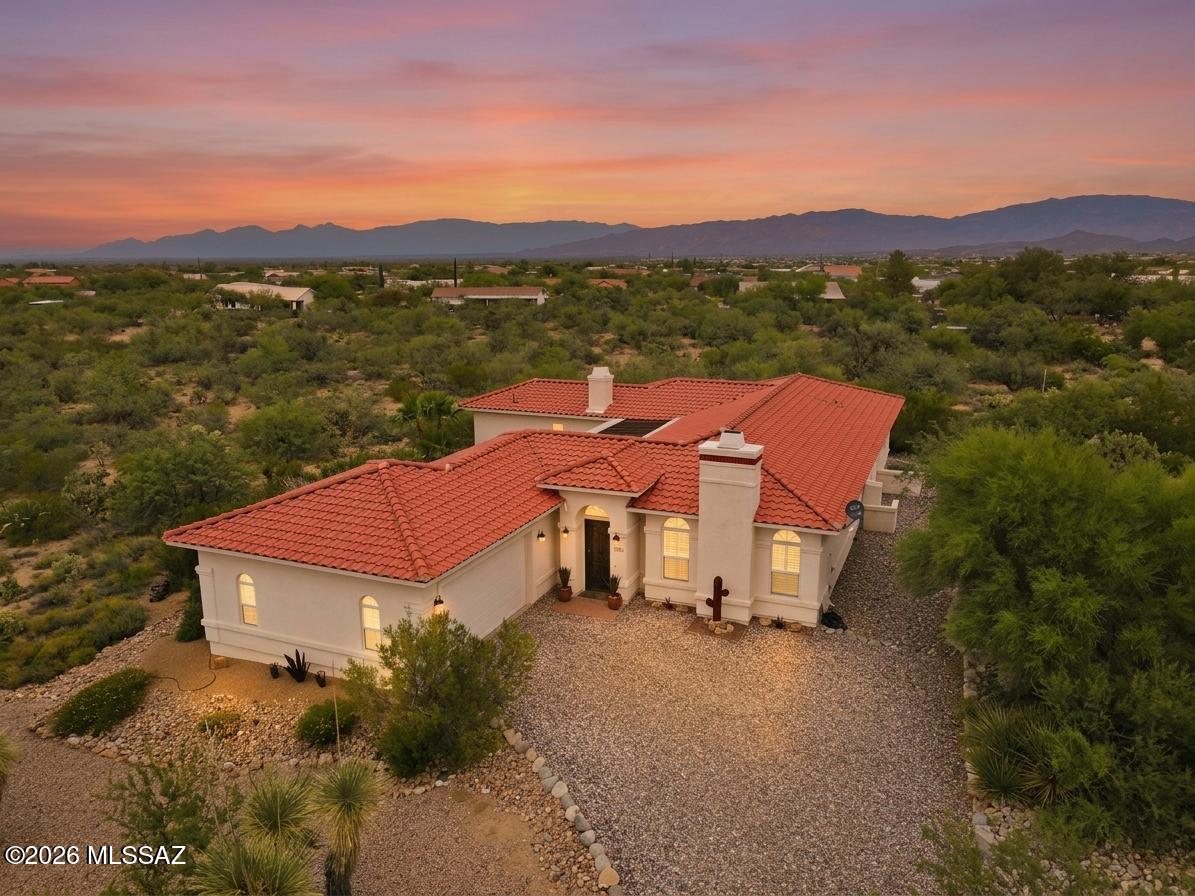 🌵 Desert Charm Meets Modern Comfort 🌄 Welcome to your own slice of private Sonoran paradise! Amazing opportunity for 2,228 SqFt, split floor plan, 3 bed/2 full bath, all electric Southwestern modern contemporary home with finished 590 SqFt, 2.5 car garage, the freedom of no HOA, located in desirable New Tucson neighborhood in the vaunted Vail School district. Custom-built in 2003 by the original owners and lovingly maintained ever since. Immaculate condition with pride of ownership evident throughout! Single story, no stairs, no steps on spacious 1.0 acre CR1 lot, NE/SE orientation, concrete tile roof, low maintenance beautifully landscaped front and back yards. Enter through the custom iron security door into a beautiful, covered 822 SqFt courtyard with slate tile flooring-- a peaceful, private space that feels like an extension of the home. The courtyard provides convenient access to the garage, the main entrance to the home, and a separate entrance directly into the primary suite, making it an incredibly functional and relaxing outdoor living space.
Inside experience soaring 12' painted ceilings (no popcorn), energy efficient dual pane windows, plantation shutters, window blinds, tile flooring throughout, recessed lighting, wired for alarm, 2018 new HVAC, digital thermostat, 2020 new water heater, internal laundry room with sink, washer and dryer included, shaker internal doors, ceiling fans, living room with wood burning fireplace and built-in entertainment center, gorgeous exposed wood beam columns add warmth and character to the formal dining area, conveniently located just off the living room. The kitchen is highlighted by stunning full-slab Silestone countertops with a beautiful sparkling blue finish, creating a unique, elegant focal point that really catches the eye. Enjoy bar seating, stainless steel appliance package including convection double oven, built-in microwave, refrigerator with ice/water dispenser, matching dishwasher, metal undermount double sink and maple shaker kitchen cabinets, adjacent to breakfast area. Spacious guest bedrooms complement the massive primary suite designed for comfort and privacy, featuring a wood-burning beehive fireplace and private outdoor access. The ensuite bathroom offers executive-height dual sinks with Corian countertops, a grand jetted tub, separate walk-in shower and spacious walk-in closet. Looking for a quiet, serene modern home with privacy on an acre? Priced below the $562,980 RVM property value report, call to make an appointment to view this beautiful home for yourself today!