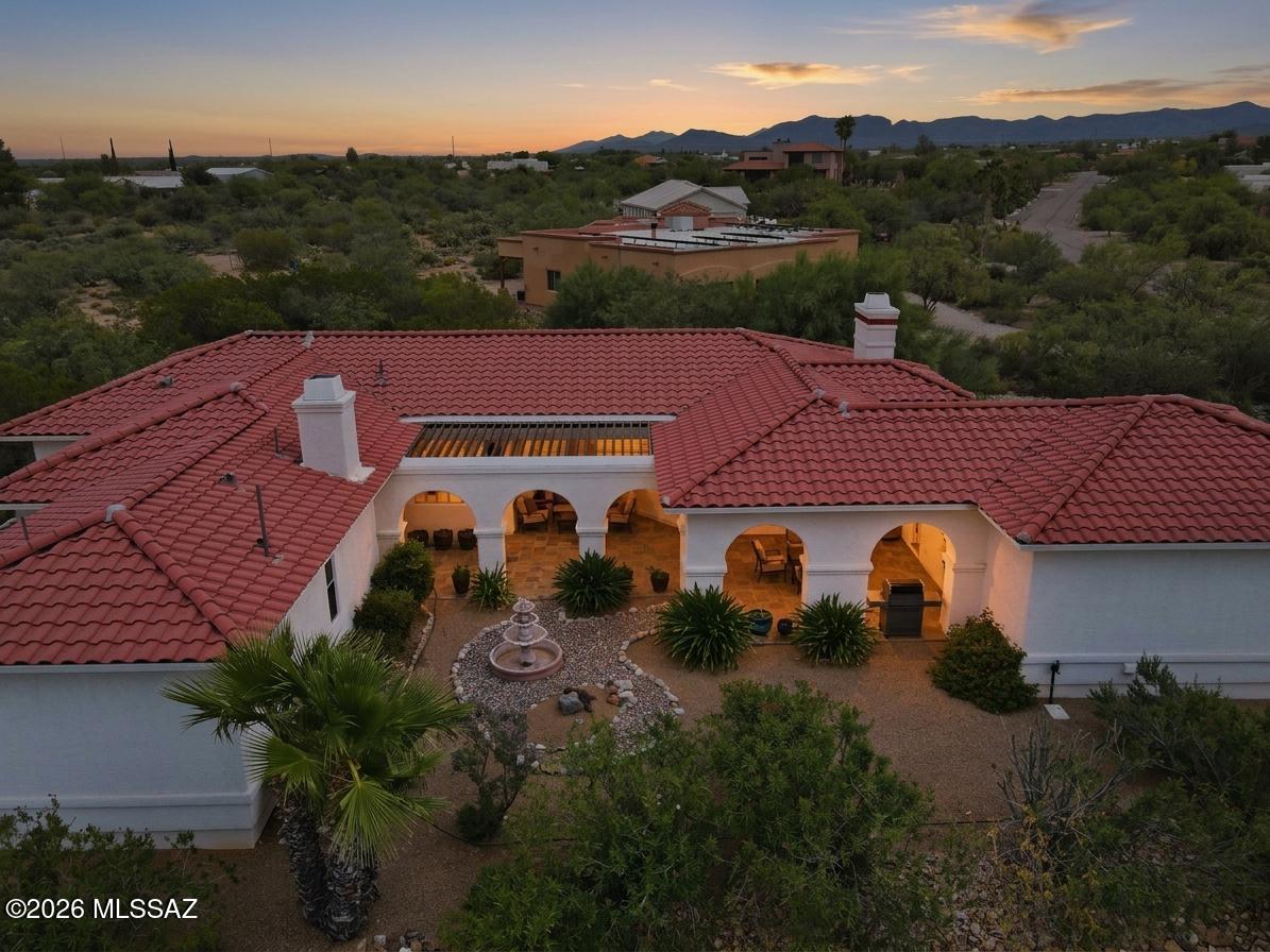 🌵 Desert Charm Meets Modern Comfort 🌄 Welcome to your own slice of private Sonoran paradise! Amazing opportunity for 2,228 SqFt, split floor plan, 3 bed/2 full bath, all electric Southwestern modern contemporary home with finished 590 SqFt, 2.5 car garage, the freedom of no HOA, located in desirable New Tucson neighborhood in the vaunted Vail School district. Custom-built in 2003 by the original owners and lovingly maintained ever since. Immaculate condition with pride of ownership evident throughout! Single story, no stairs, no steps on spacious 1.0 acre CR1 lot, NE/SE orientation, concrete tile roof, low maintenance beautifully landscaped front and back yards. Enter through the custom iron security door into a beautiful, covered 822 SqFt courtyard with slate tile flooring-- a peaceful, private space that feels like an extension of the home. The courtyard provides convenient access to the garage, the main entrance to the home, and a separate entrance directly into the primary suite, making it an incredibly functional and relaxing outdoor living space.
Inside experience soaring 12' painted ceilings (no popcorn), energy efficient dual pane windows, plantation shutters, window blinds, tile flooring throughout, recessed lighting, wired for alarm, 2018 new HVAC, digital thermostat, 2020 new water heater, internal laundry room with sink, washer and dryer included, shaker internal doors, ceiling fans, living room with wood burning fireplace and built-in entertainment center, gorgeous exposed wood beam columns add warmth and character to the formal dining area, conveniently located just off the living room. The kitchen is highlighted by stunning full-slab Silestone countertops with a beautiful sparkling blue finish, creating a unique, elegant focal point that really catches the eye. Enjoy bar seating, stainless steel appliance package including convection double oven, built-in microwave, refrigerator with ice/water dispenser, matching dishwasher, metal undermount double sink and maple shaker kitchen cabinets, adjacent to breakfast area. Spacious guest bedrooms complement the massive primary suite designed for comfort and privacy, featuring a wood-burning beehive fireplace and private outdoor access. The ensuite bathroom offers executive-height dual sinks with Corian countertops, a grand jetted tub, separate walk-in shower and spacious walk-in closet. Looking for a quiet, serene modern home with privacy on an acre? Priced below the $562,980 RVM property value report, call to make an appointment to view this beautiful home for yourself today!
