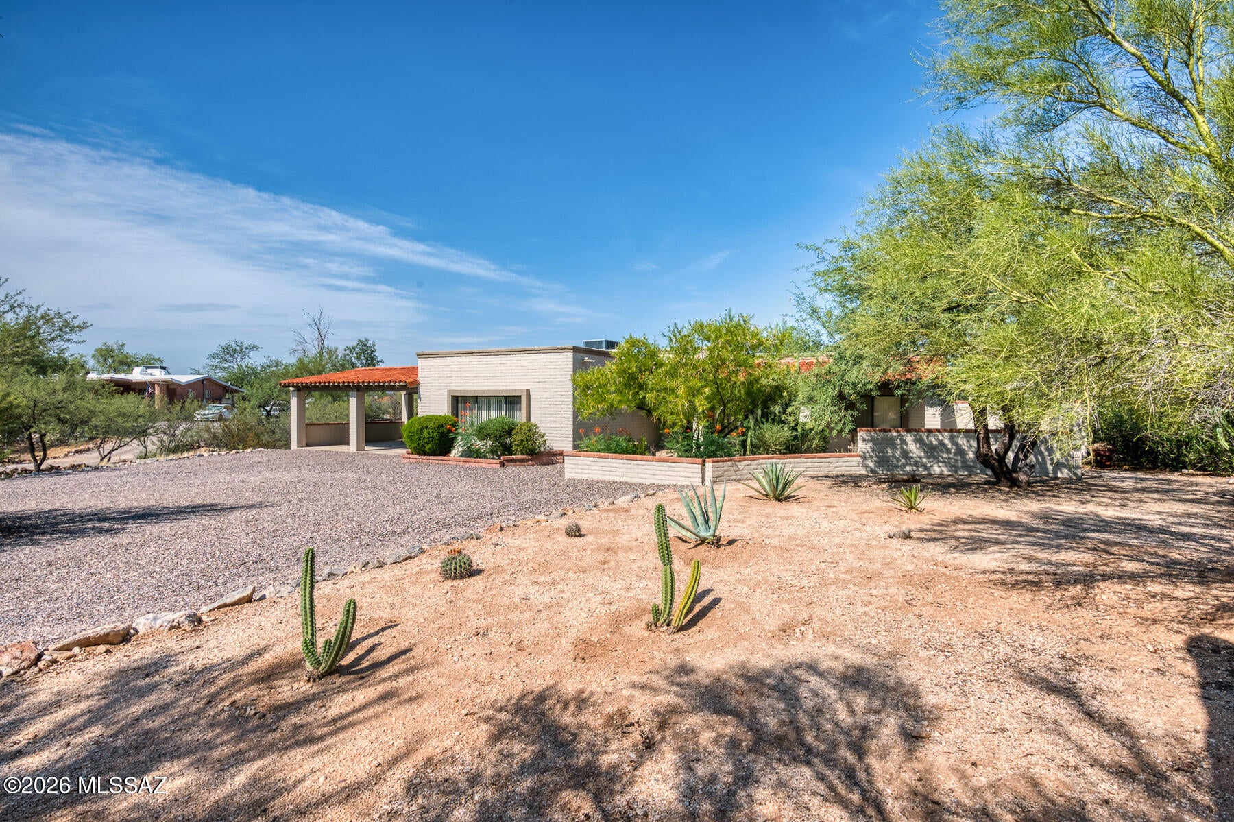 Price Improvement makes this custom-built territorial style home even more attractive.  Desirable location near great dining, shopping & excellent schools. 
This masonry home sits nestled on a .93 acre fenced lot with a sparkling Pebbletec pool, mature vegetation and inviting outdoor spaces.  The home features mountain views, privacy and quiet and no HOA. It has a welcoming dramatic foyer and a spacious family room with a fireplace.  Inviting wood flooring in bedrooms and saltillo tile in main areas are perfect for our desert environment. The primary bedroom has dual walk-in closets. Charming screen porch is perfect for outdoor dining and year round enjoyment. There is also an outbuilding which incorporates a quiet studio & a workshop.  Welcome Home!