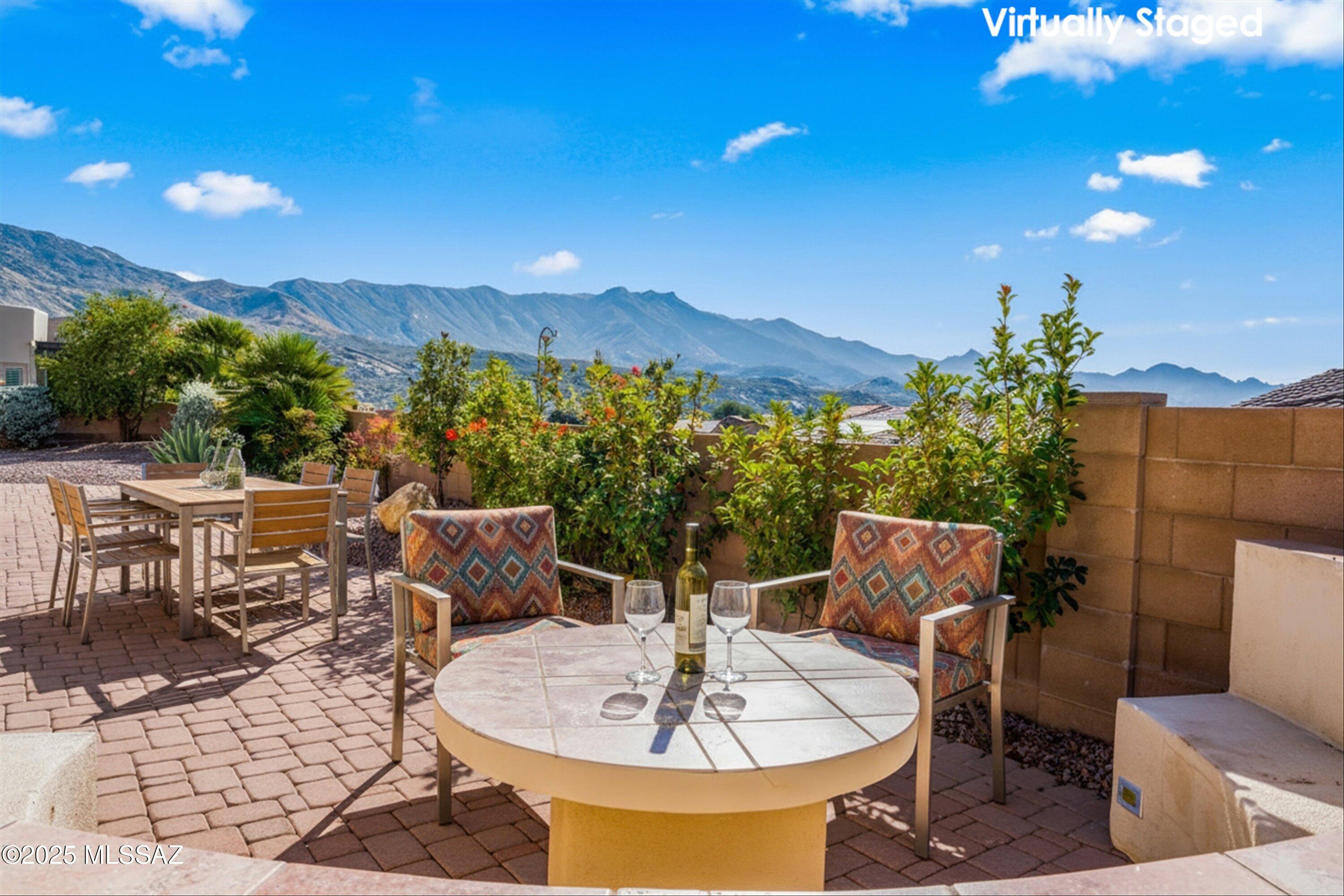 This extensively upgraded Sabino model is ready for you to move right in. A welcoming courtyard leads you inside, where you'll find striking accent colors and contemporary décor throughout. The spacious great room features a stacked stone gas fireplace—perfect for chilly evenings. The open kitchen boasts premium stainless appliances and advanced storage solutions, including two pull-out pantry cabinets and a ''lazy Charlie'' for easy access to a large corner cabinet. Adjacent to the kitchen, the Morning Room offers versatile functionality and overlooks the courtyard. 
The sophisticated accent colors extend into the primary suite, which boasts a bay window creating a comfortable sitting area with scenic views. The updated en-suite bathroom is tastefully designed with abundant cabinetry, dual vanities, and a walk-in tiled shower. Guests will appreciate the privacy of a guest suite with its own en-suite bathroom. Additional amenities include a conveniently located den, powder room, a three-car side-load garage, and a screened Arizona room.
The expanded patio, complete with a built-in bench and table carefully positioned for optimal mountain views, provides an excellent setting to enjoy the changing colors of the mountains at sunset. This property offers an exceptional opportunity to experience the unparalleled SaddleBrooke lifestyle.