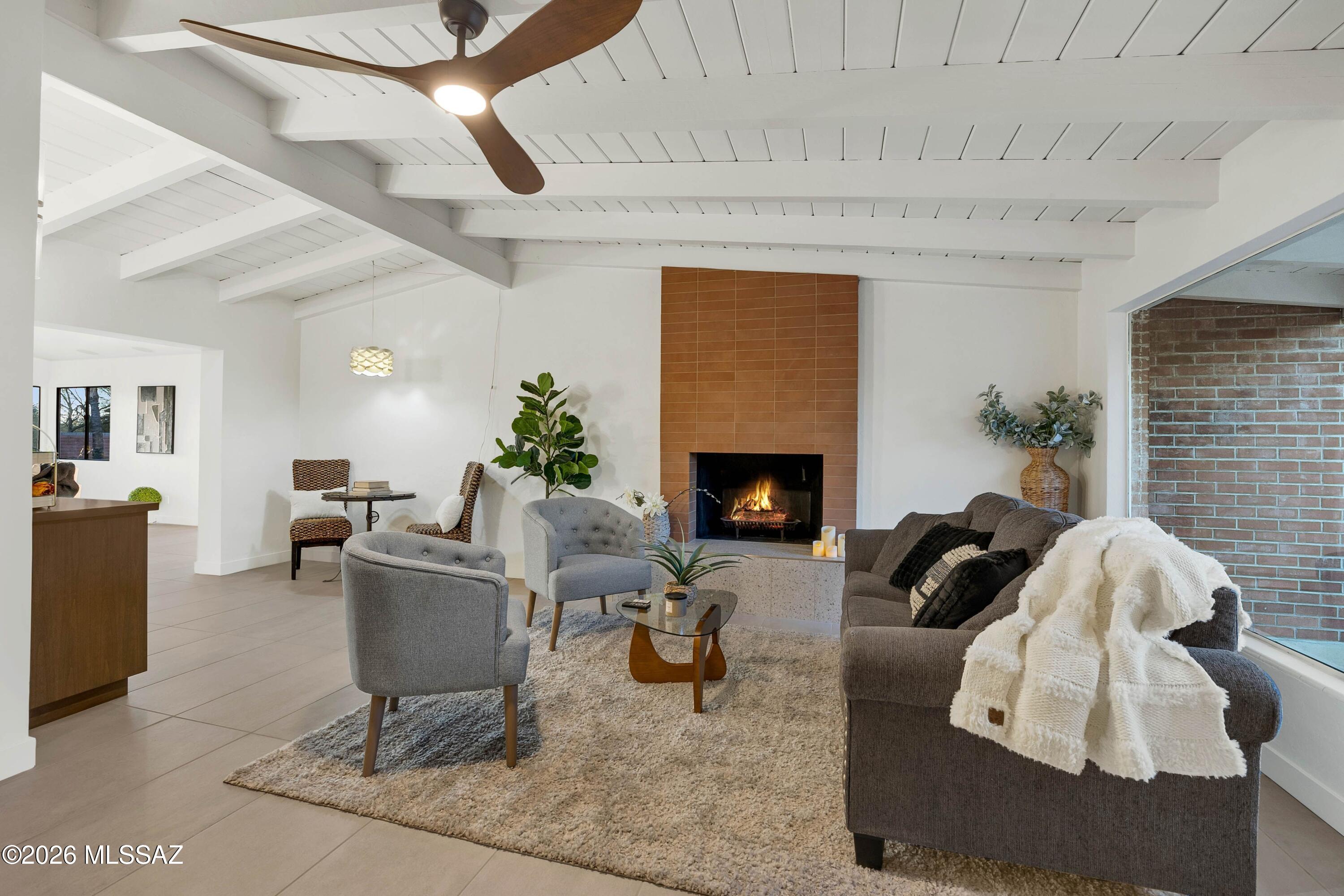Beautifully updated 1953 mid-century ranch blending timeless architecture with modern comfort in a private Casas Adobes setting. Close to shops, dining, & everyday conveniences, this home offers ideal privacy, character, & lifestyle. Inside, vaulted tongue-and-groove ceilings add warmth & charm throughout. The remodeled kitchen features KitchenAid appliances, abundant storage, & a walk-in pantry. Floor plan includes 4 bedrooms, 3 baths, office, & a versatile bonus room with closet & private outdoor access. The primary suite offers patio access, walk-in closet, & spa-like bath with dual vanity & oversized tiled shower. Enjoy a resort-style backyard with pool, hot tub, lush grass, & mature landscaping. 3-car garage completes the home.