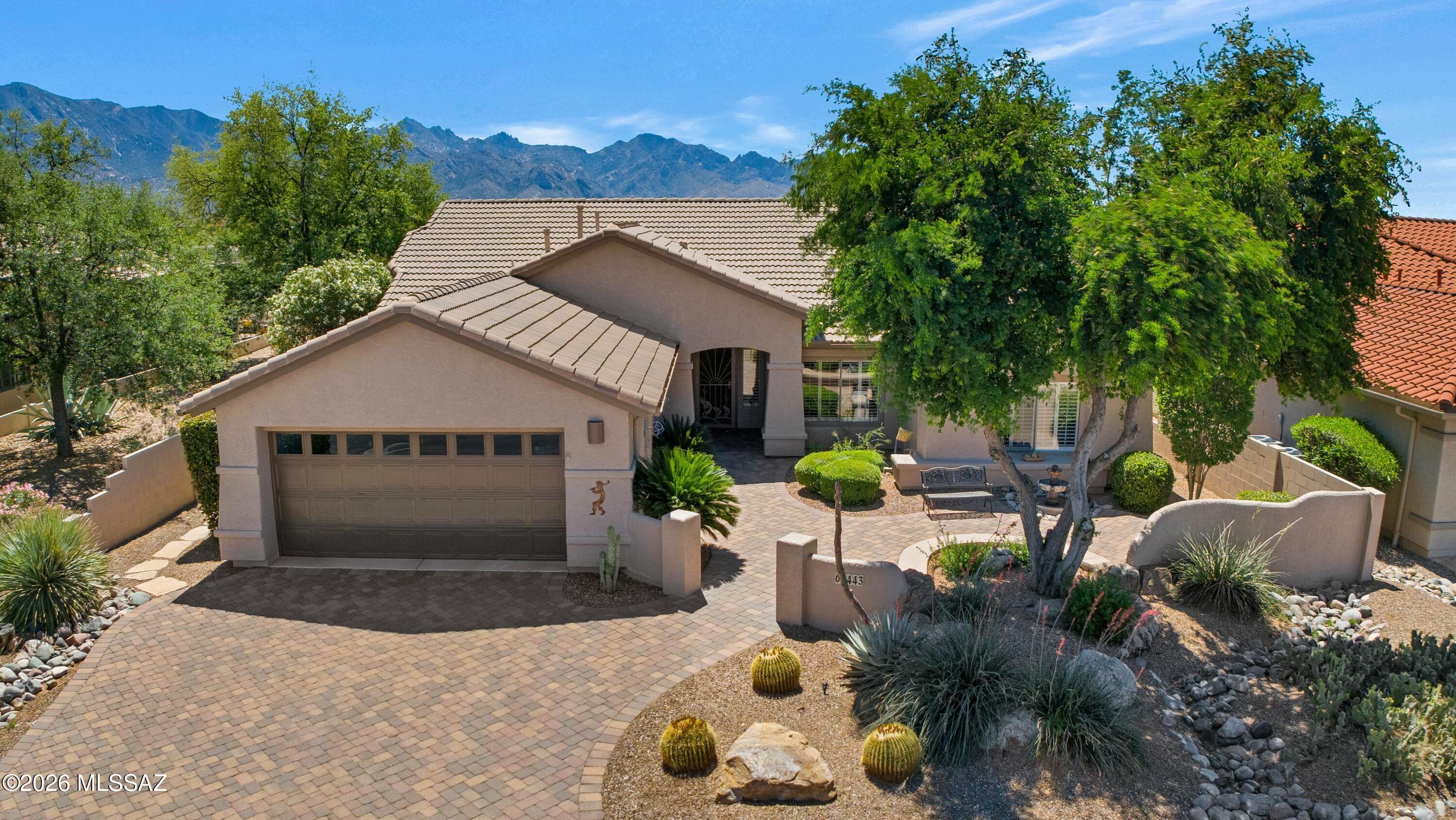 Montana with Mountain Views & Great Curb Appeal! Paver driveway leads to inviting paver courtyard with fountain. Freshly painted exterior (3/2026). Inside, spacious Great Room with wall of windows, beehive gas fireplace & slider to patio for indoor/outdoor living. Kitchen offers quartzite counters, 42'' cabinets with slide-outs, R/O system, island, desk, & kitchen nook. Den has custom built-in desk system. Owner's Suite includes bay window & patio access. EnSuite has dual vanity, walk-in shower, & walk-in closet. Guest bedroom with closet & nearby bath. Laundry room with W/D & cabinets. Plantation shutters thru-out. Extended 2-car garage with 2023 W/H, utility sink, & storage. Enjoy the covered paver patio with paver extension, 2 rolling shades, water feature, gated yard, & mountain views!